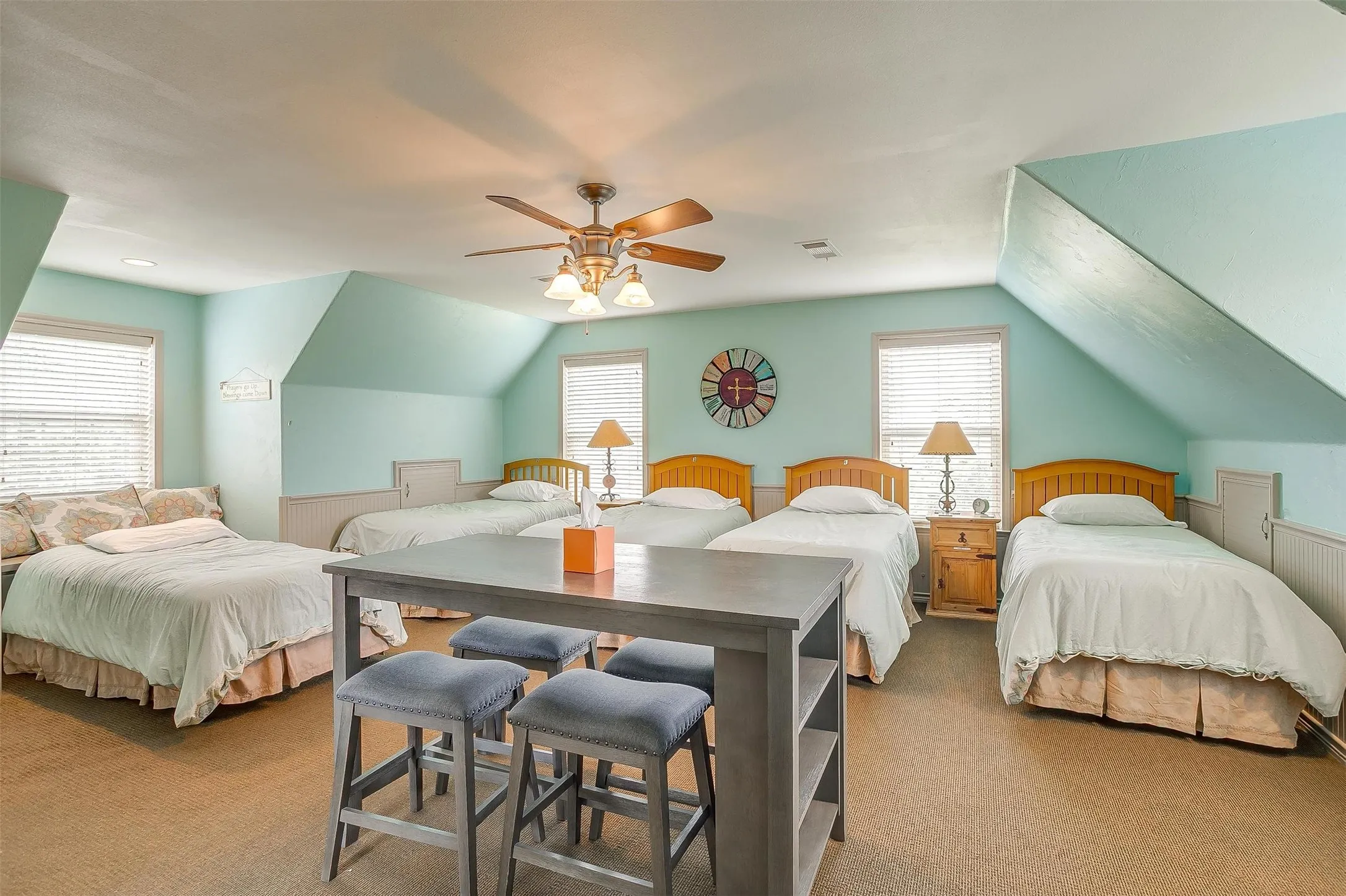 Still Water Cabin- upstairs ensuite Bedroom with carpet, wainscoting, multiple windows, a ceiling fan, and vaulted ceiling