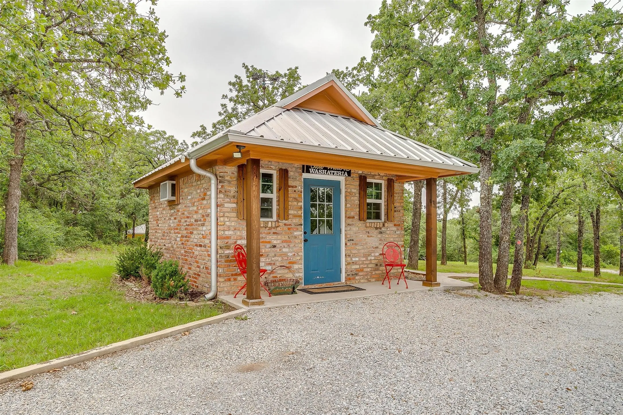 Laundry area with separate washer and dryer, cabinet space, crown molding, and light floors