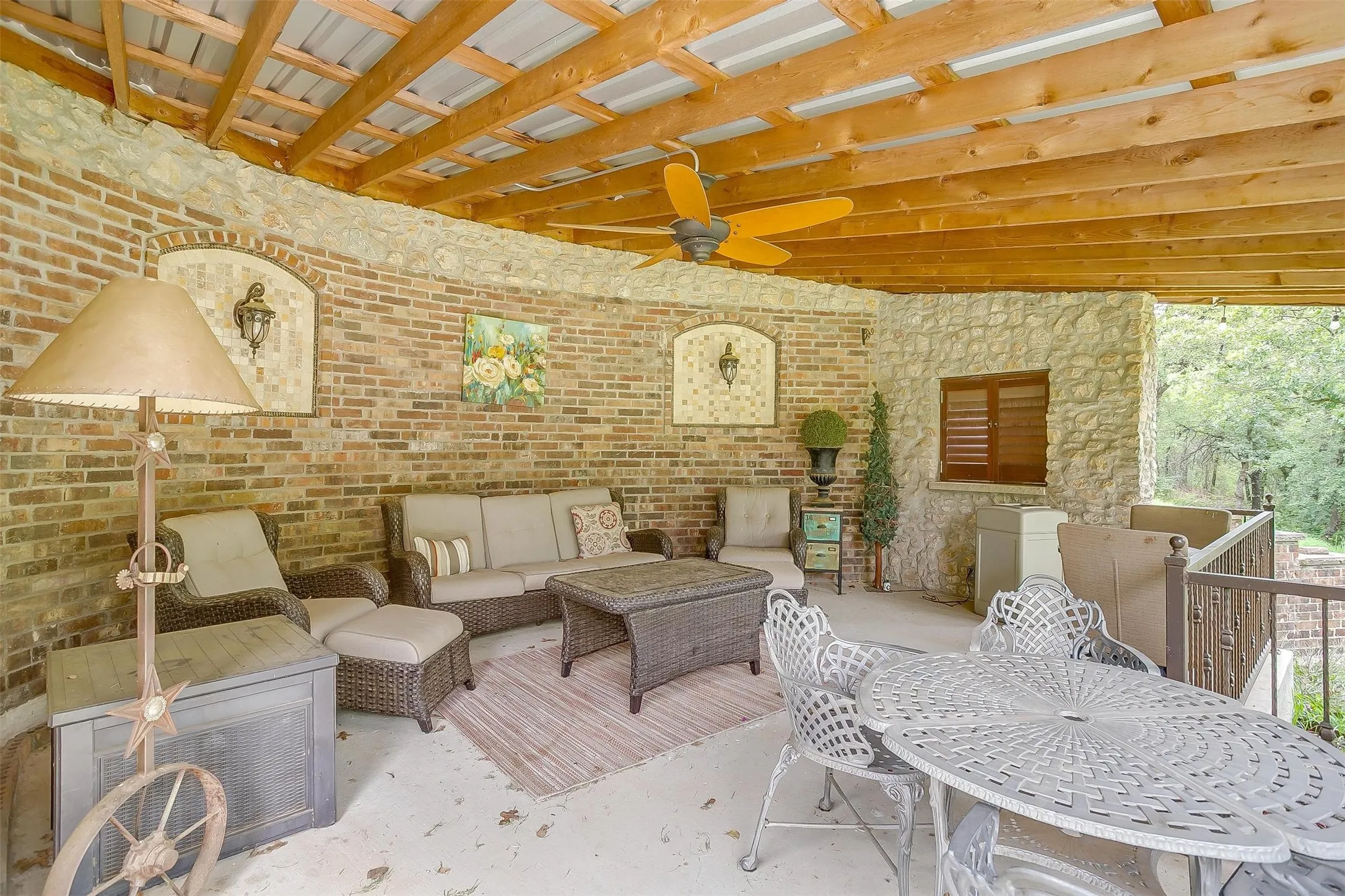 Interior view of gazebo with a ceiling fan, an outdoor living space, and outdoor dining area