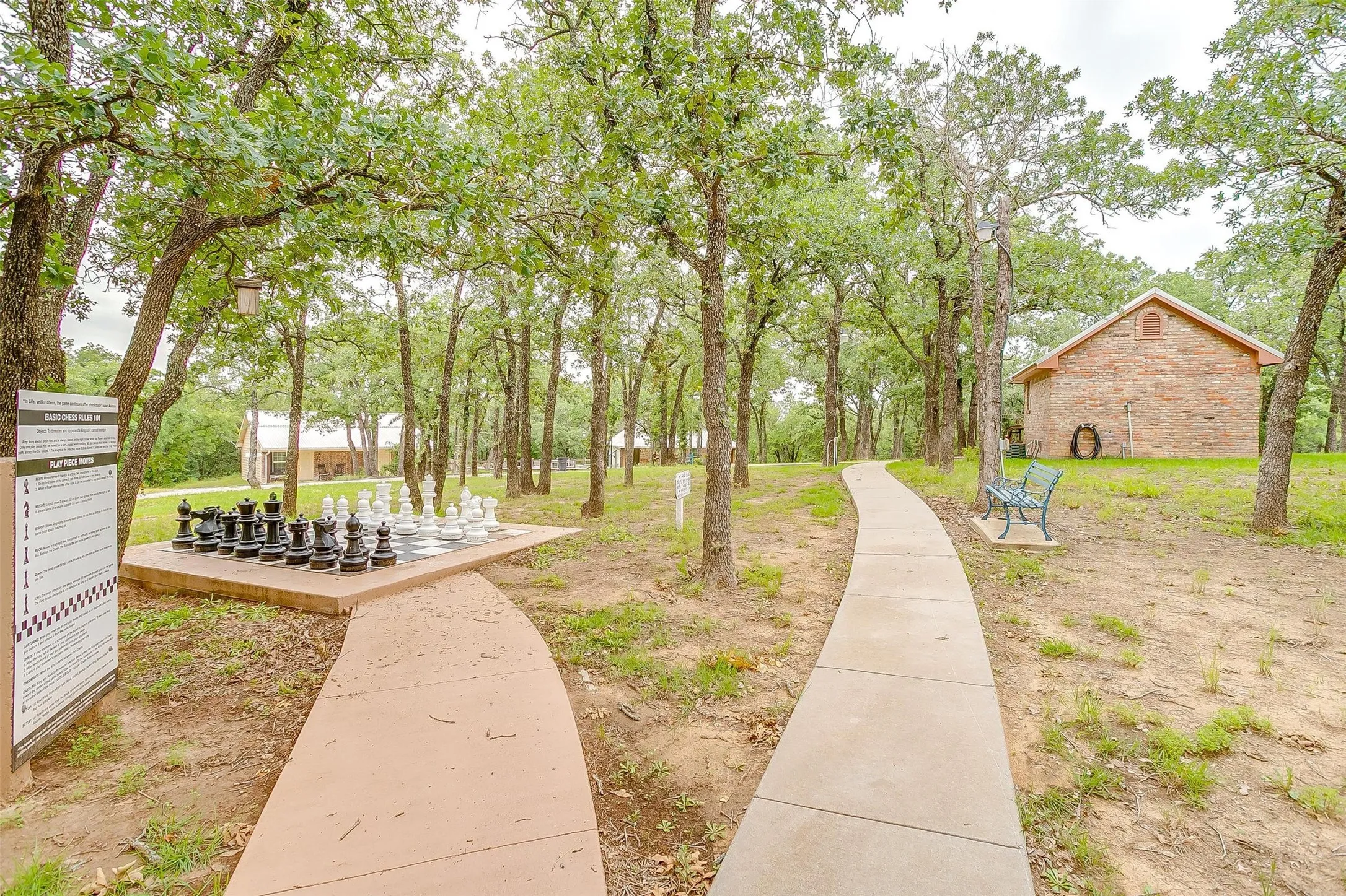 View of yard with a deck and life-size chess game.