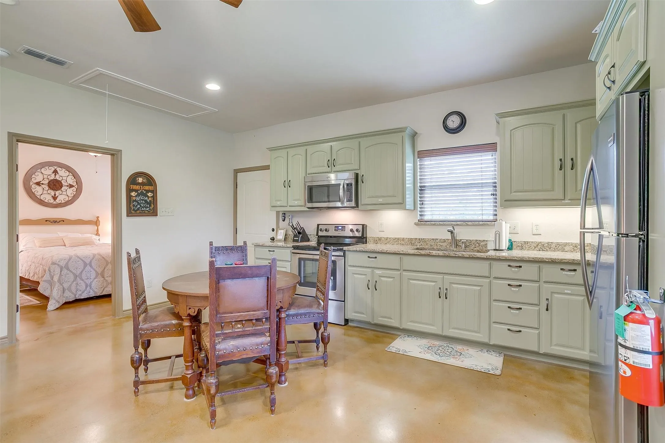 Sun Rise Cabin-Kitchen featuring green cabinets, stainless steel appliances, recessed lighting, concrete floors, and ceiling fan