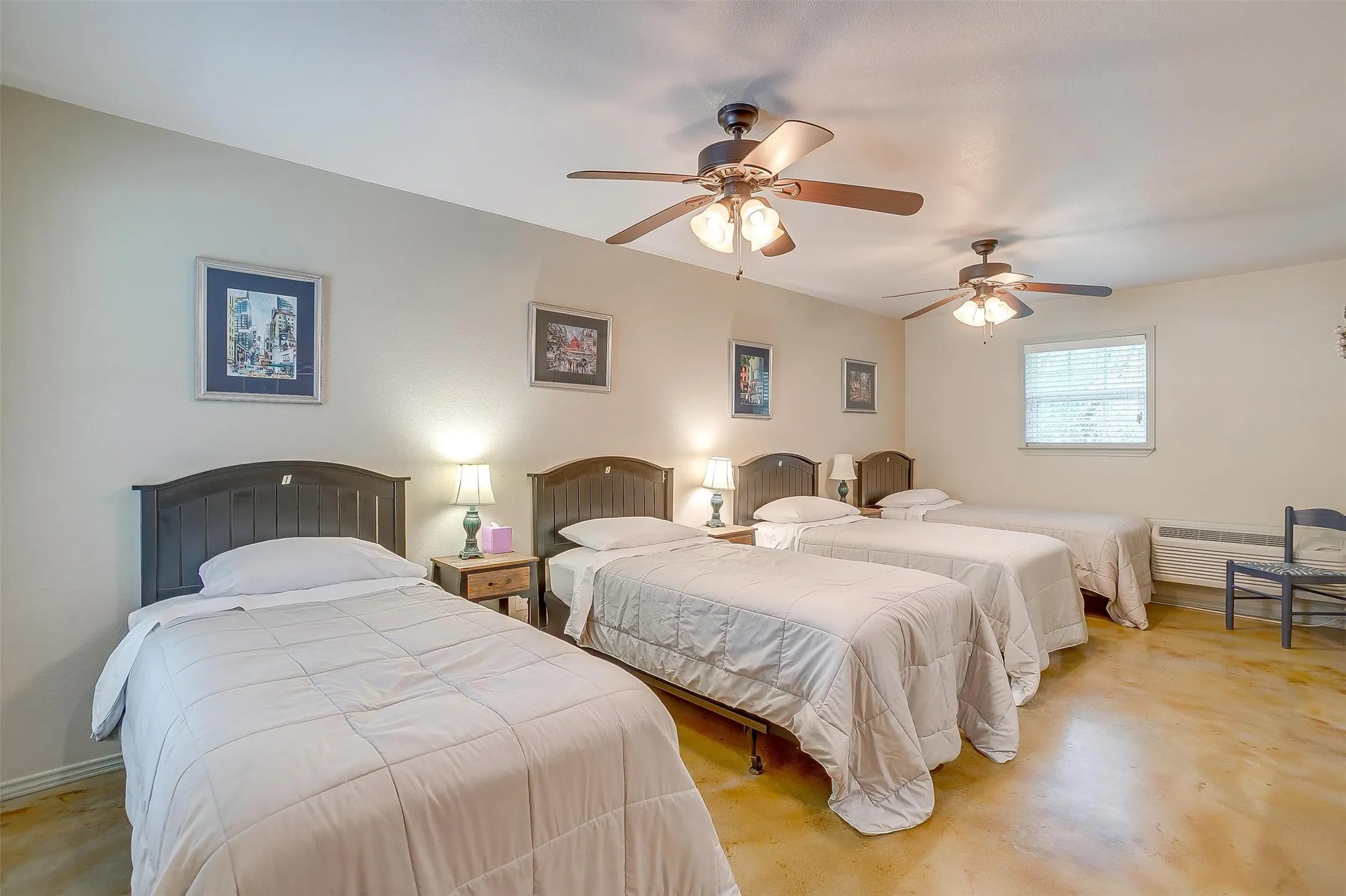 Meadows Cabins A, B, C, D- Duplex example of Bedroom with concrete flooring and ceiling fan
