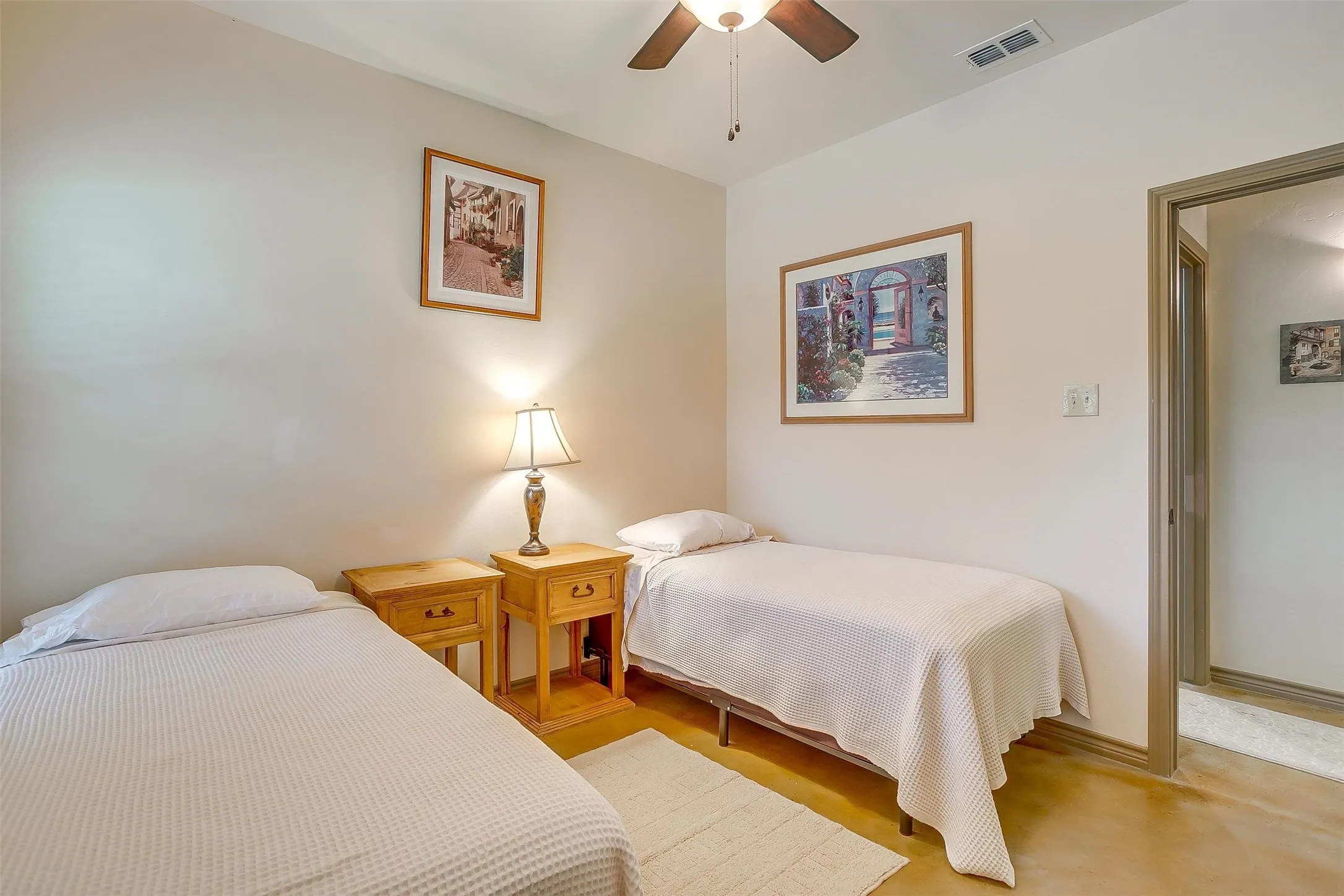 Sun Rise Cabin- 2nd Bedroom featuring finished concrete flooring and ceiling fan