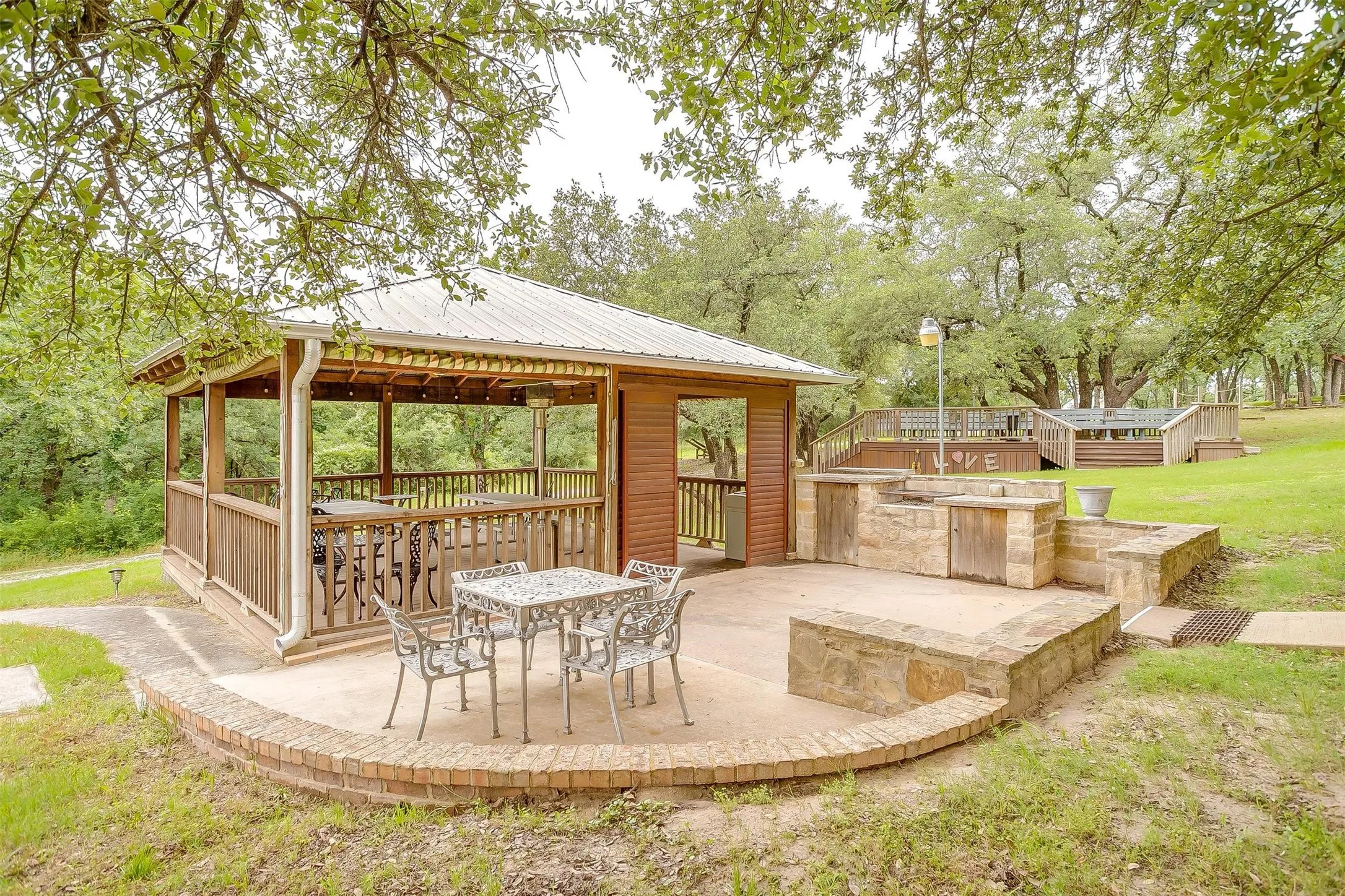 View of one of the patio areas featuring a gazebo and a wooden deck