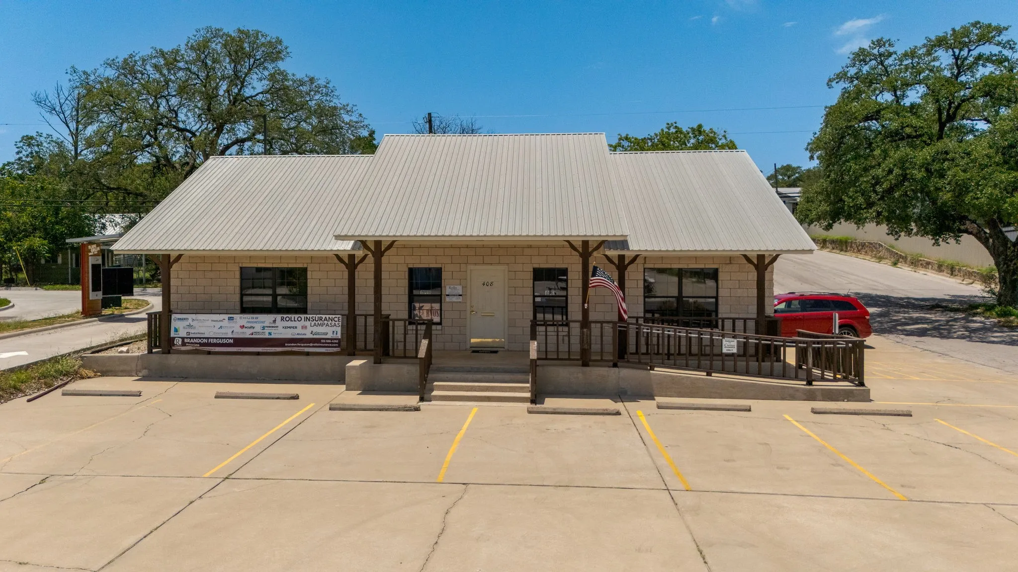 View of building exterior with uncovered parking