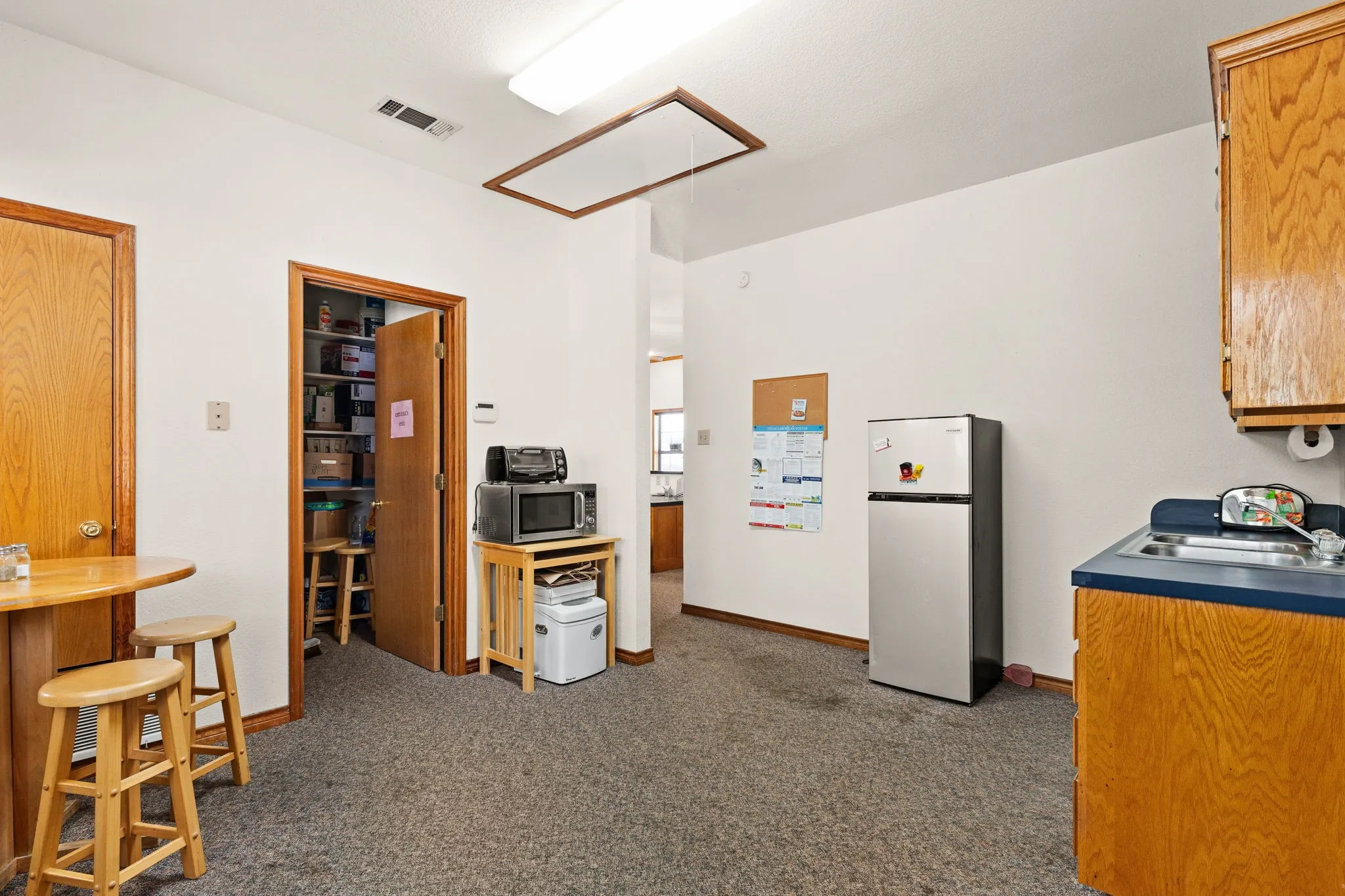 Kitchen featuring appliances with stainless steel finishes and carpet