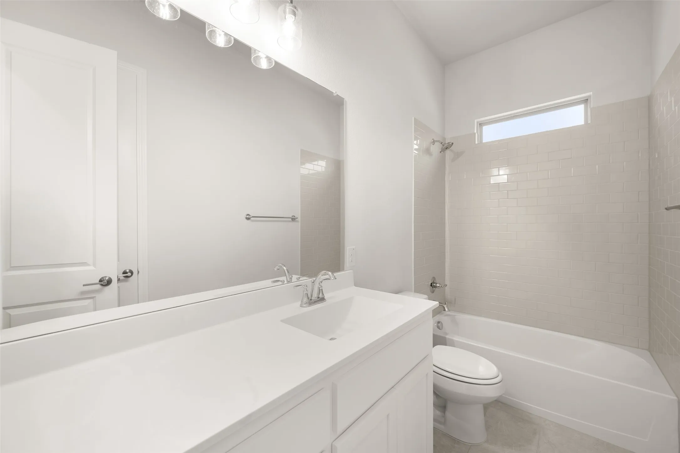 Full bath featuring vanity, bathtub / shower combination, and tile patterned floors