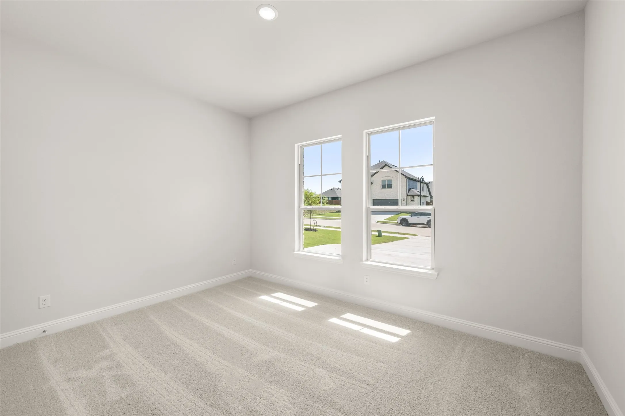 Empty room featuring carpet flooring and recessed lighting