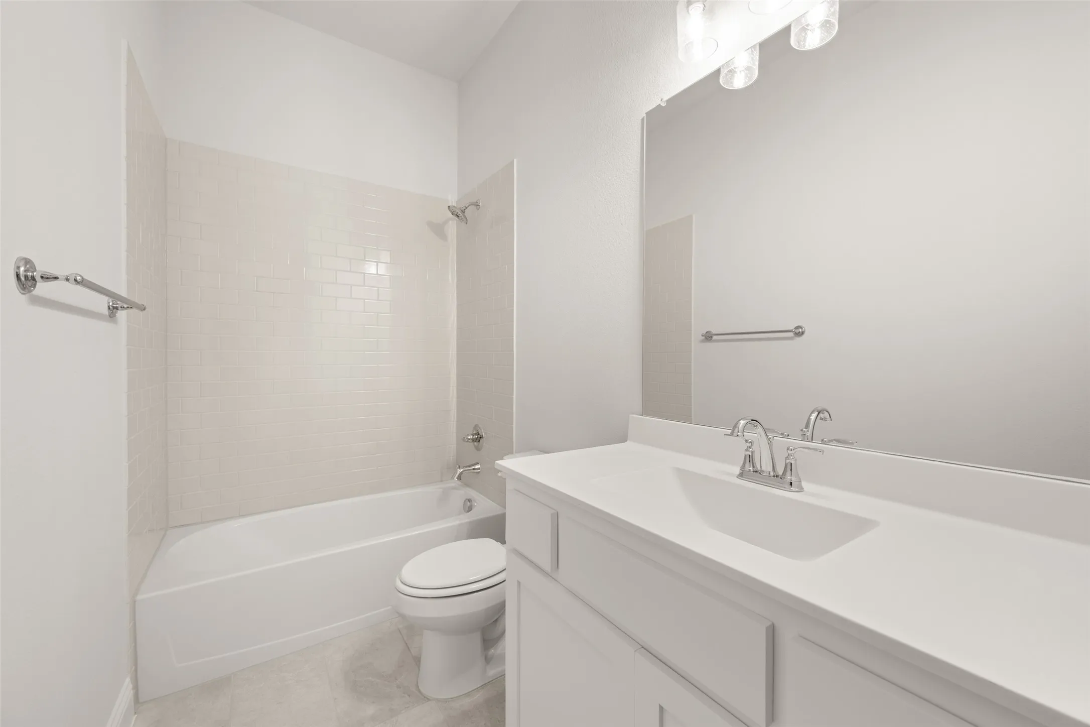 Full bathroom with vanity, bathing tub / shower combination, and tile patterned flooring