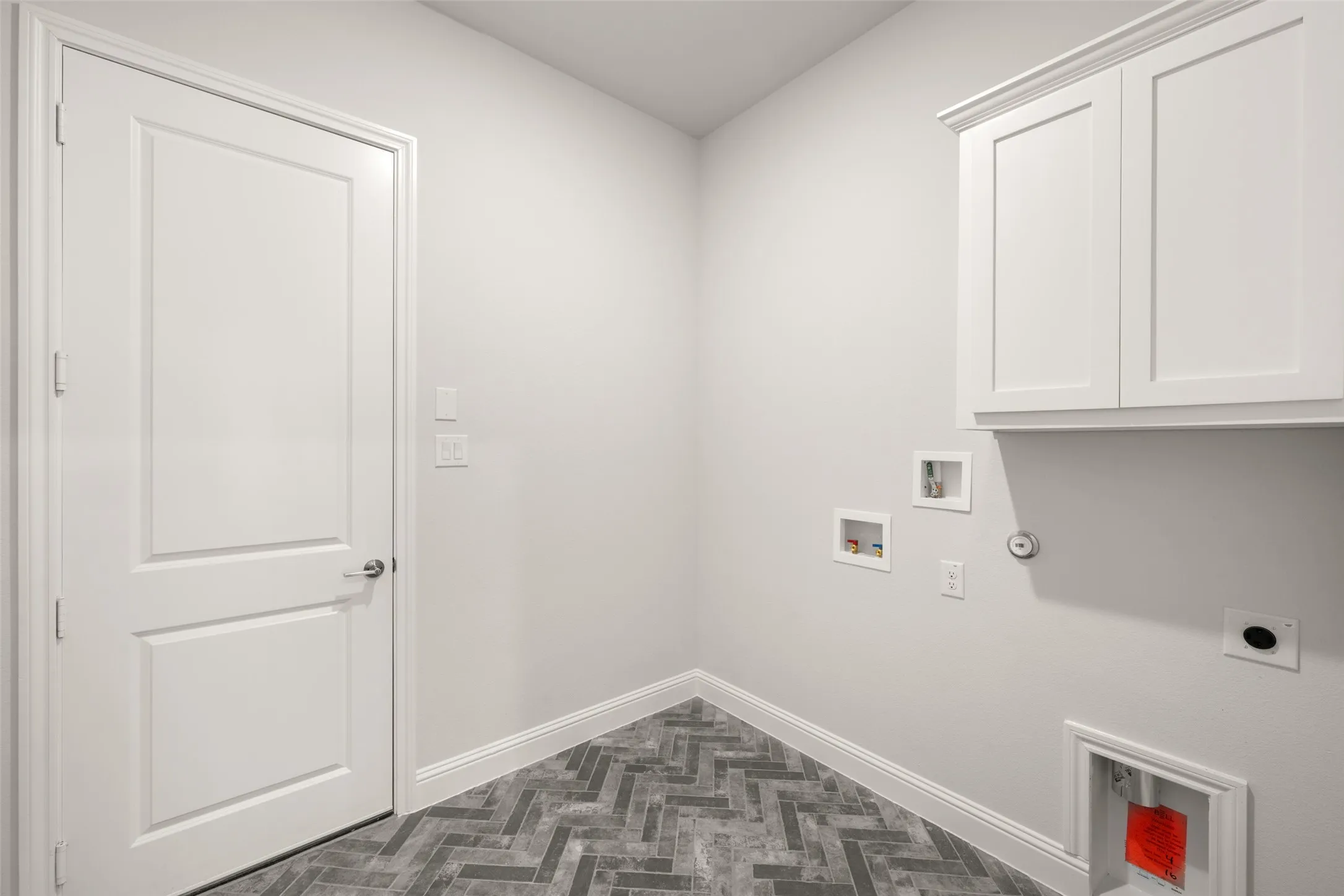 Washroom with cabinet space, hookup for an electric dryer, washer hookup, and hookup for a gas dryer