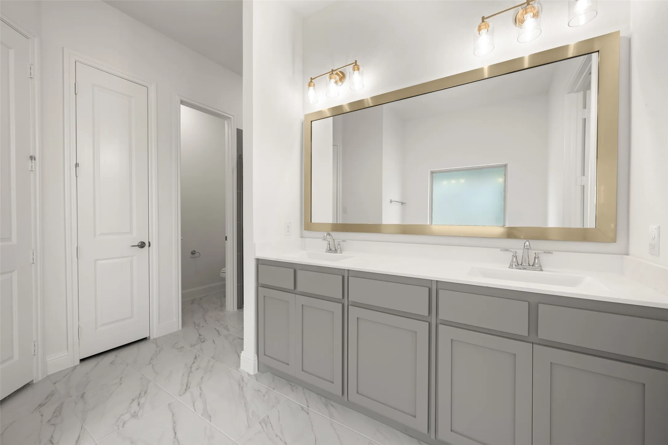 Full bathroom featuring marble finish flooring and double vanity