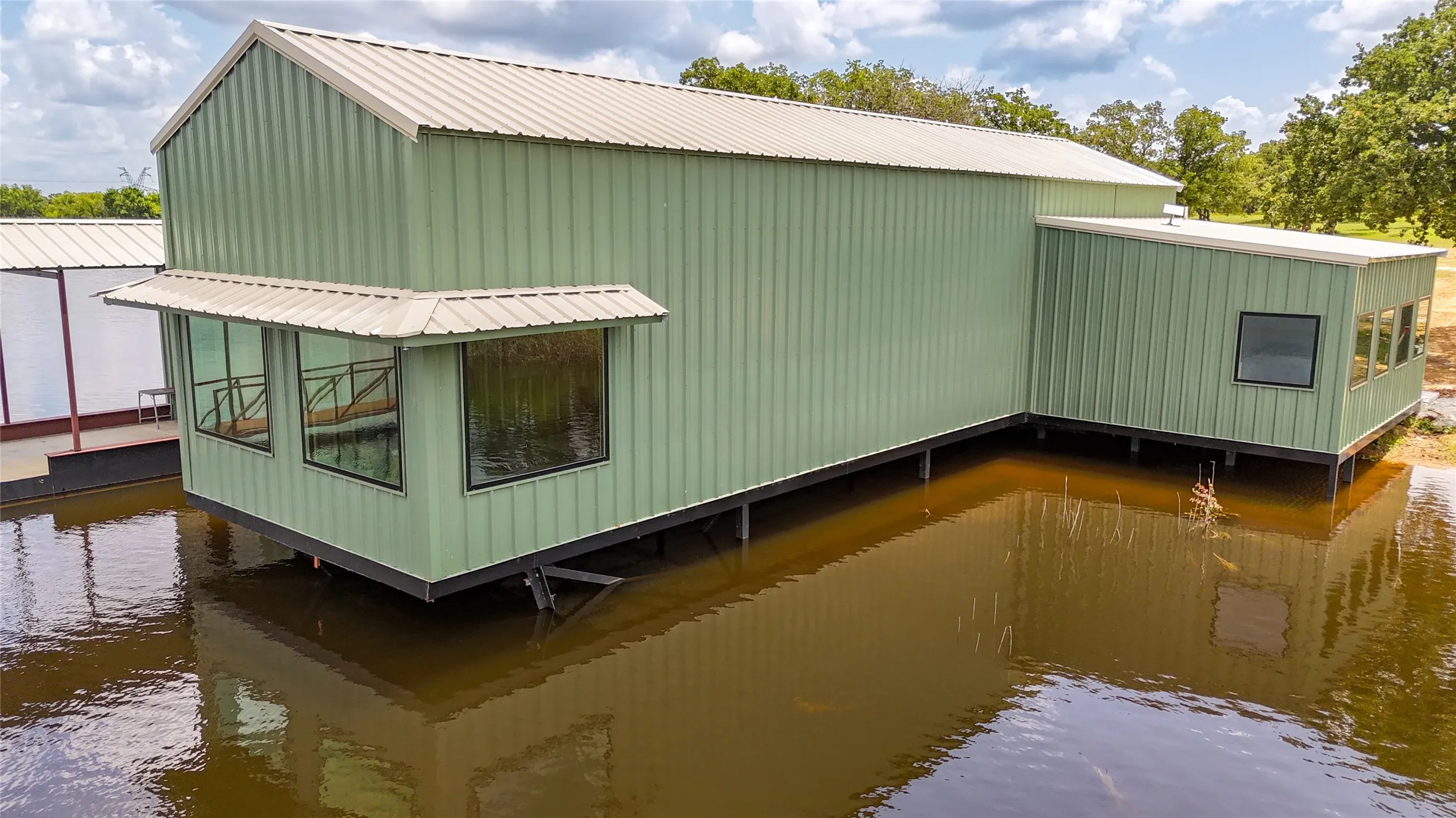 View of home's exterior featuring a water view and a metal roof