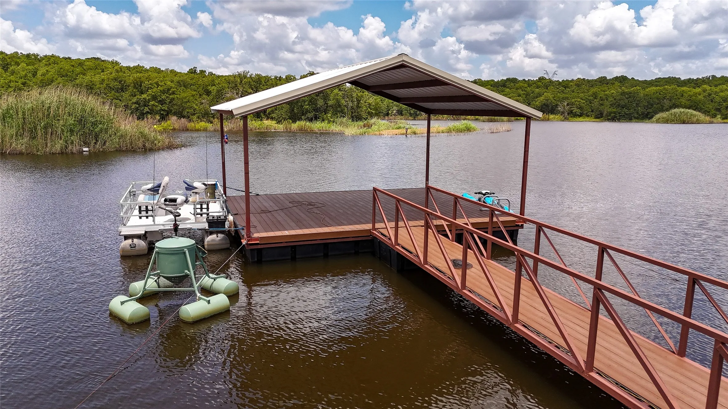 Dock area with a water view and a view of trees