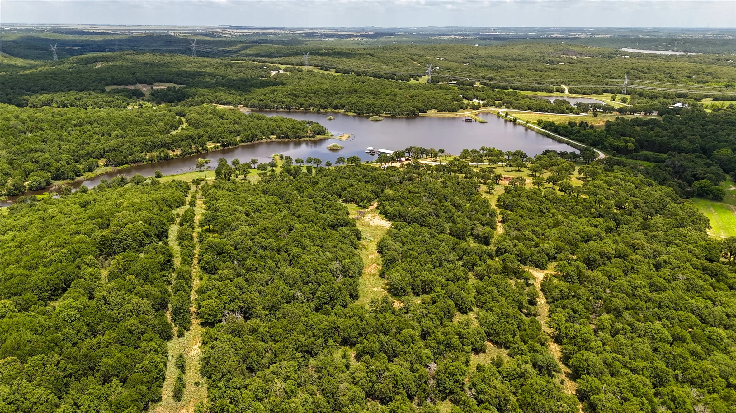 Bird's eye view of a large body of water and a heavily wooded area