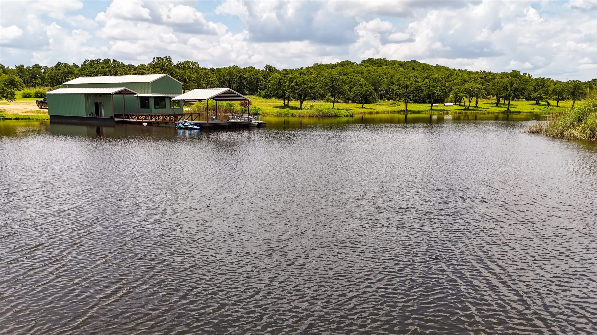 Water view featuring a dock and boat lift