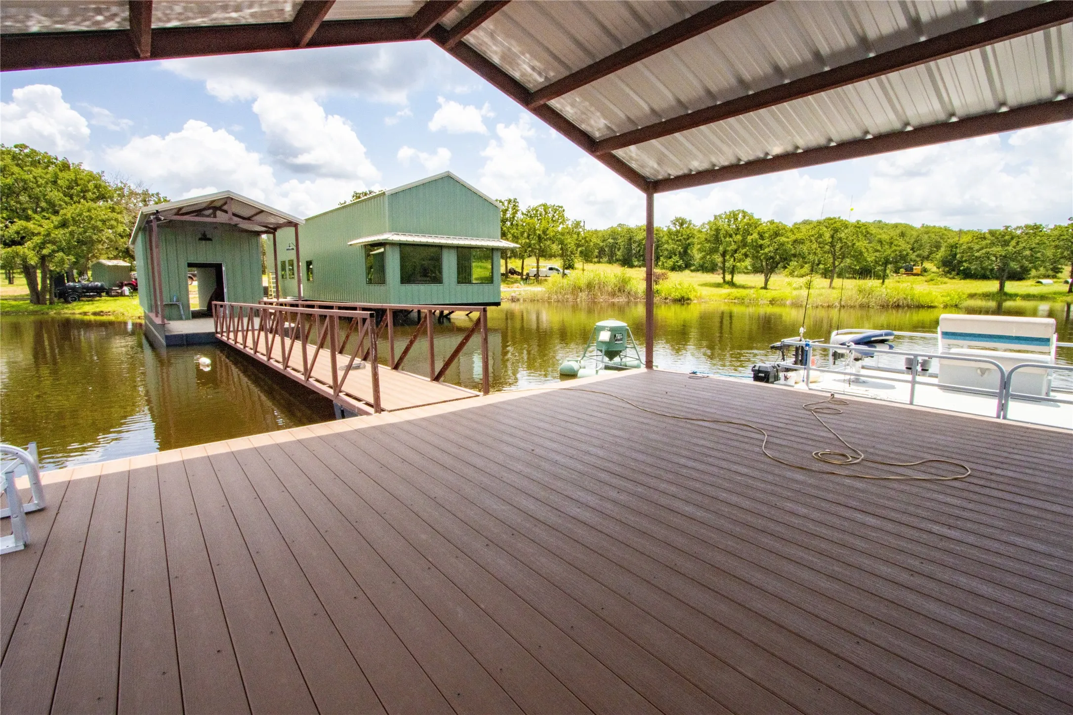Dock area featuring a water view and view of wooded area