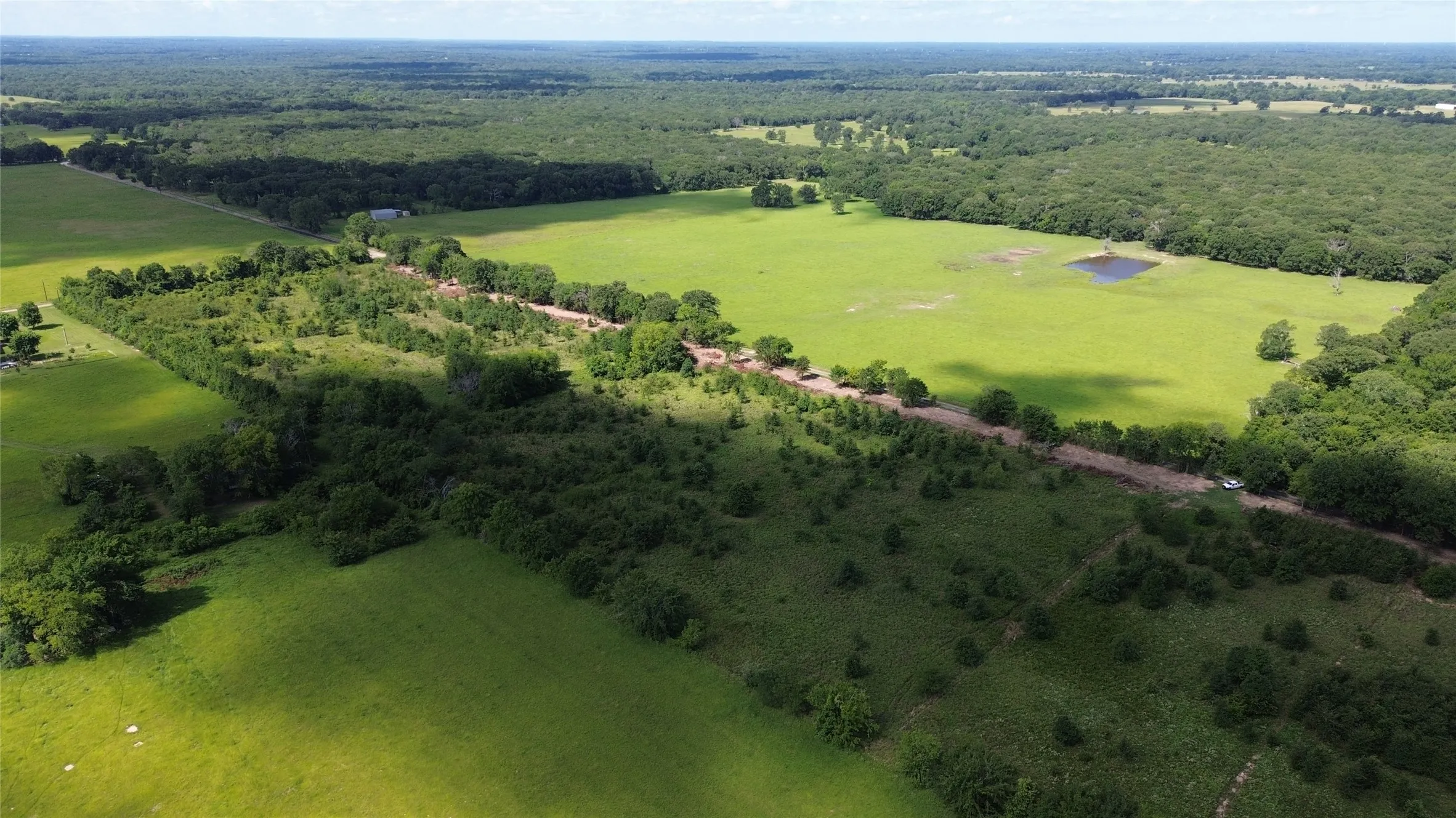 View of rural area with a heavily wooded area