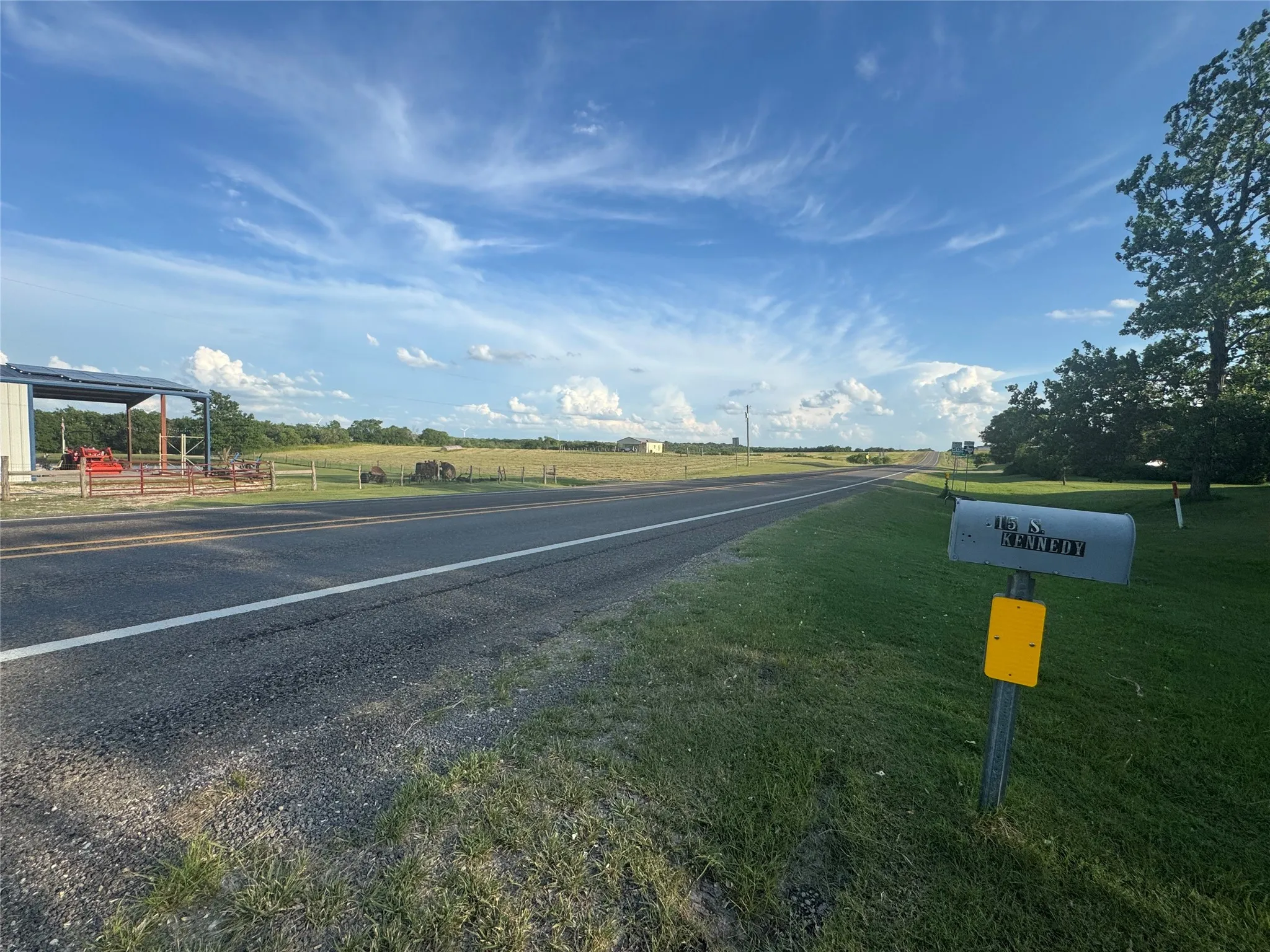 View of asphalt road featuring a view of rural / pastoral area