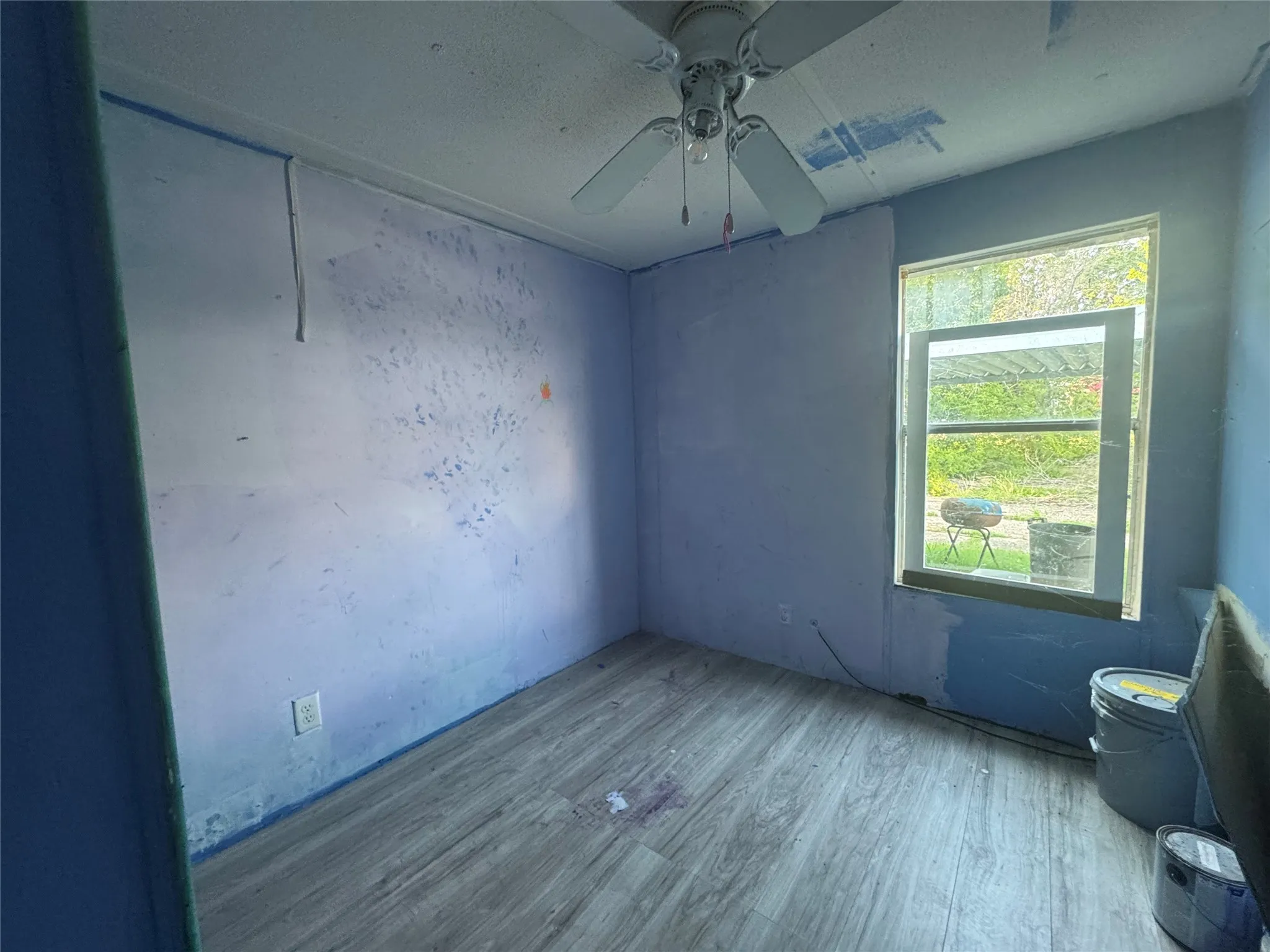 Spare room featuring wood finished floors and ceiling fan