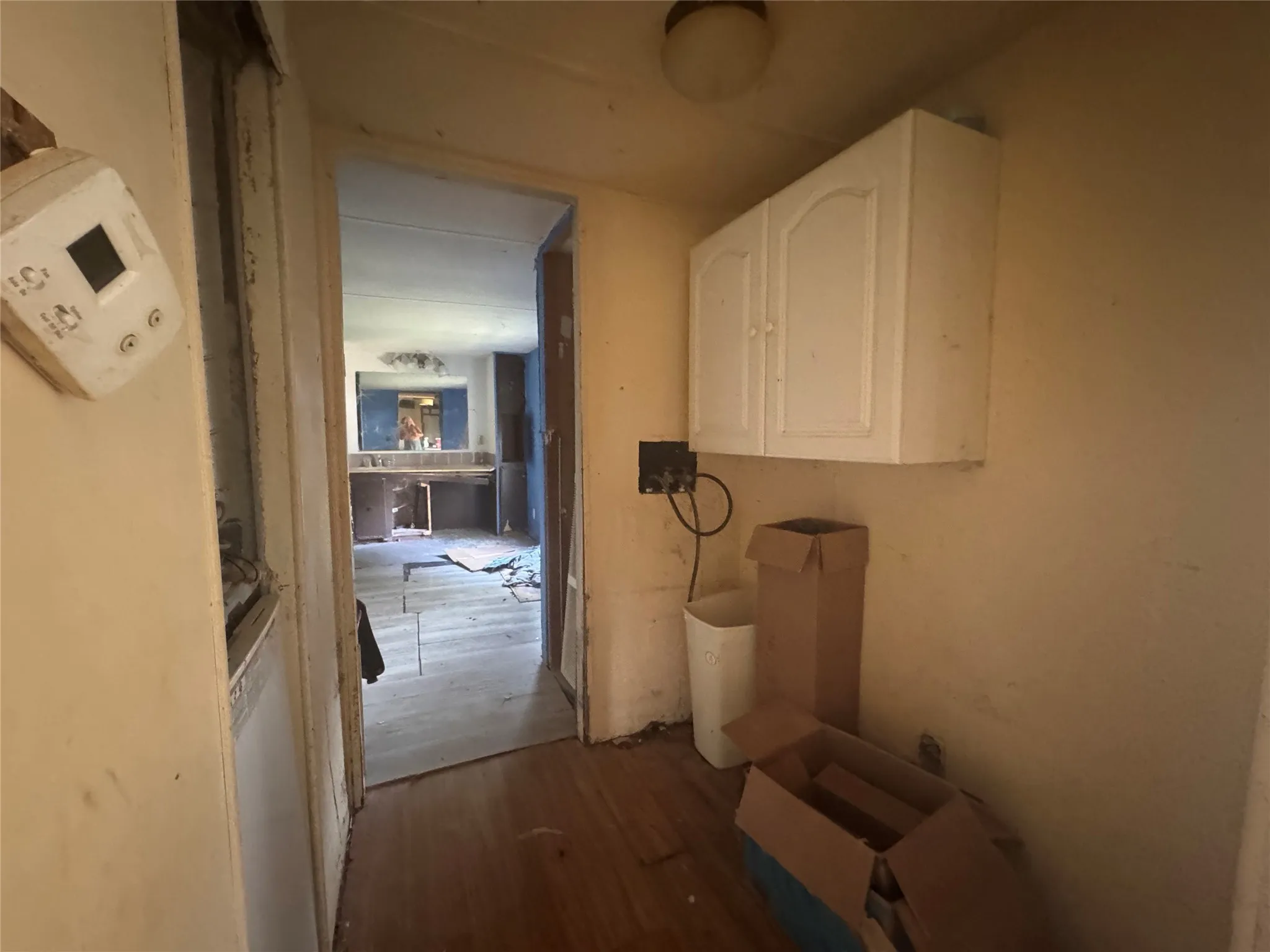 Laundry area with wood finished floors