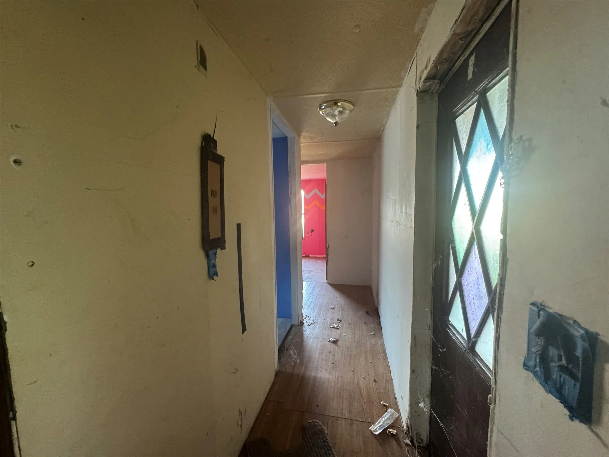 Hall with wood finished floors and healthy amount of natural light