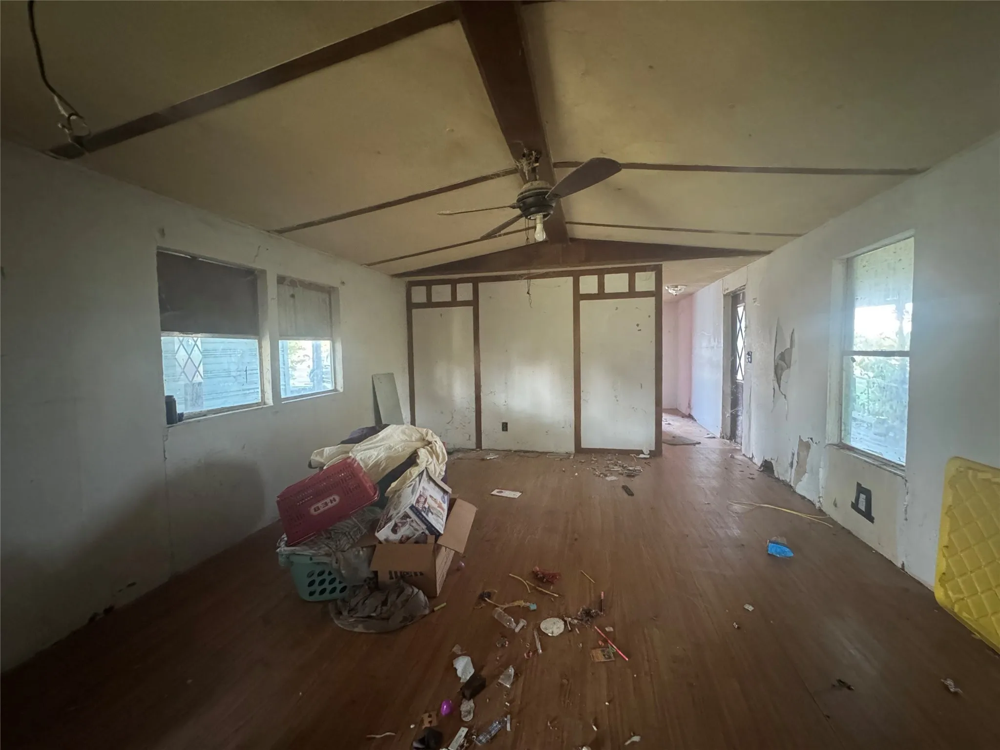 Unfurnished living room featuring wood finished floors and ceiling fan