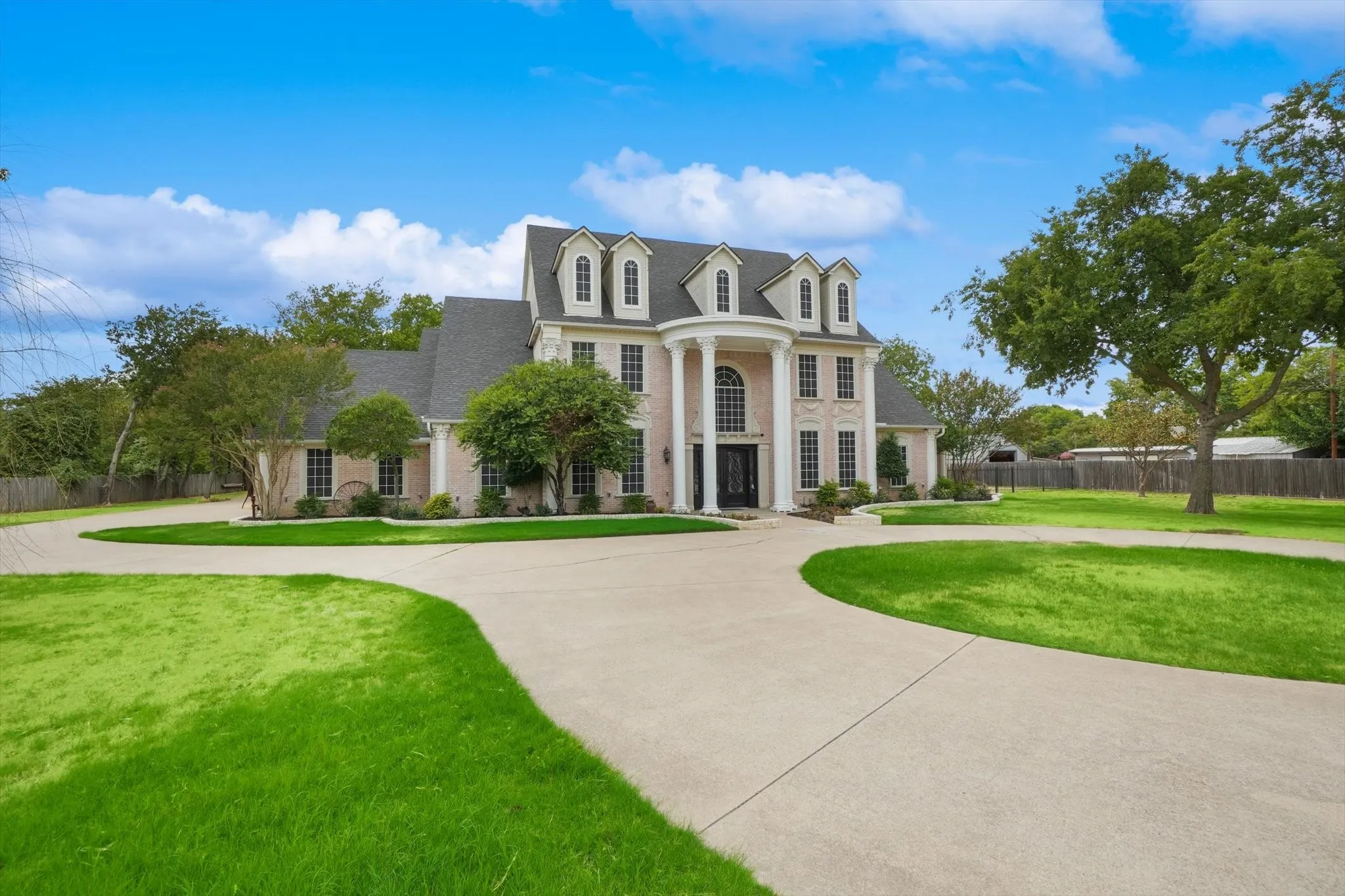 Greek revival inspired property with curved driveway