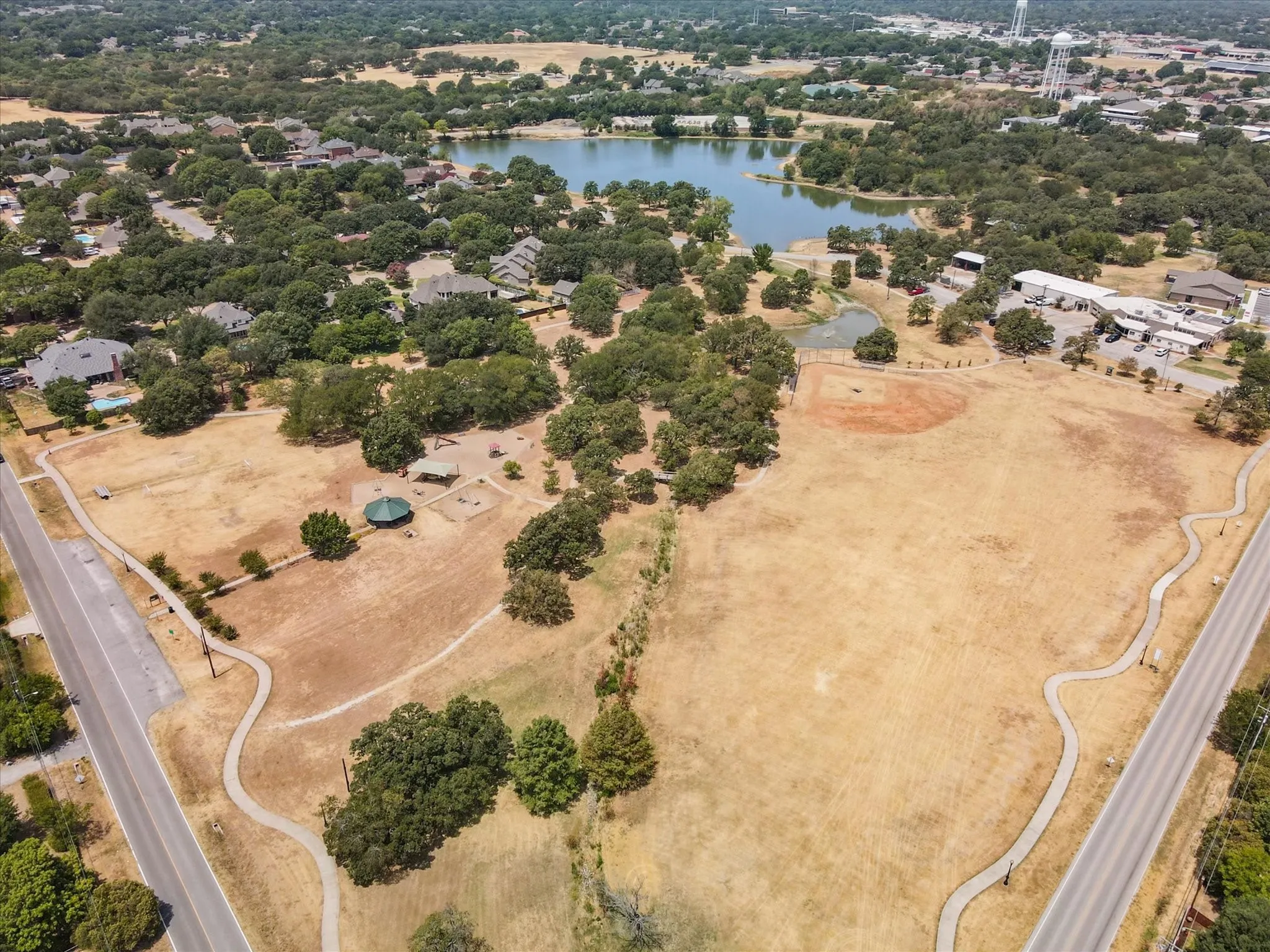 Bird's eye view of a nearby body of water and a tree filled landscape