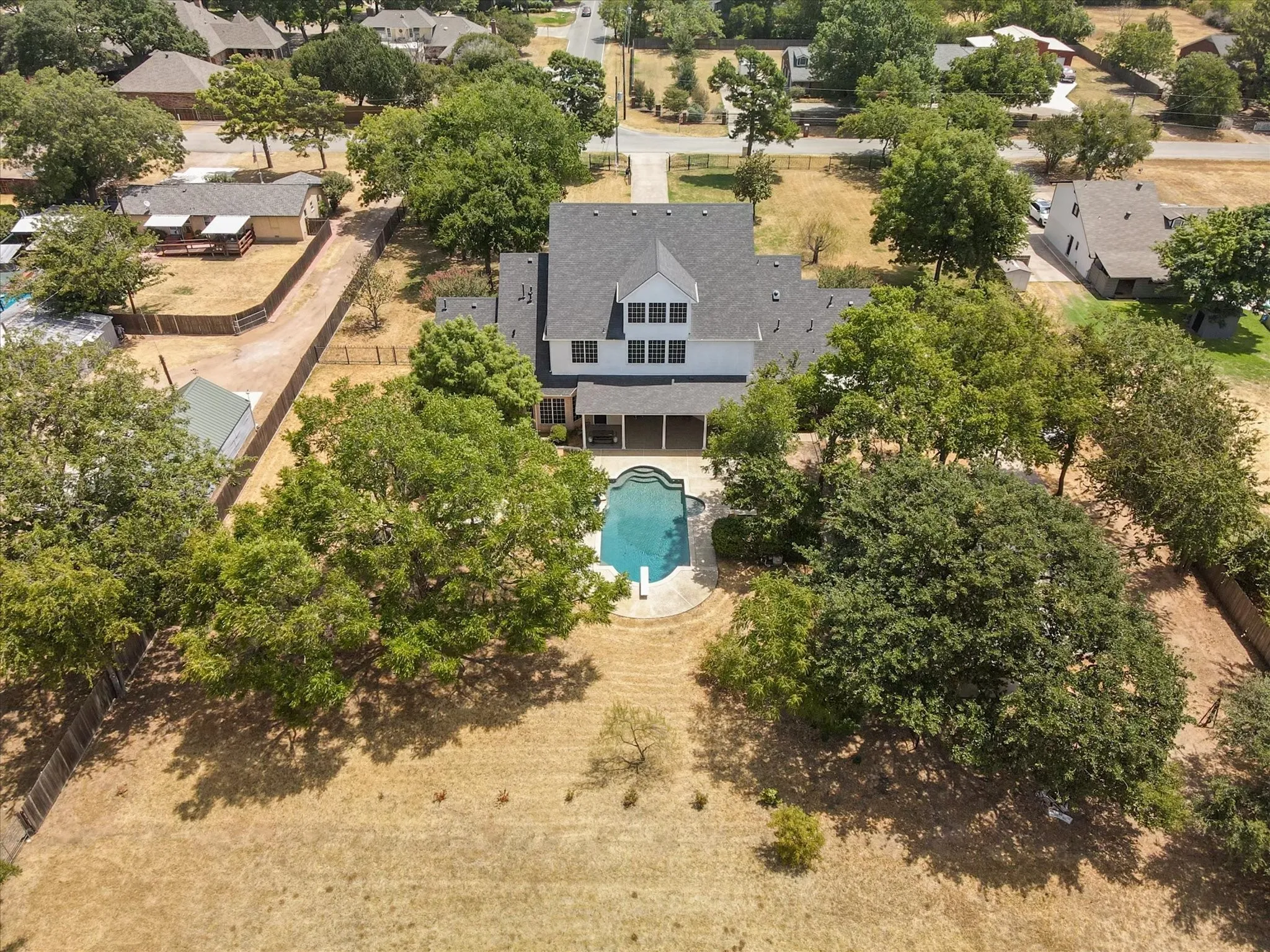 Aerial view of residential area featuring a pool