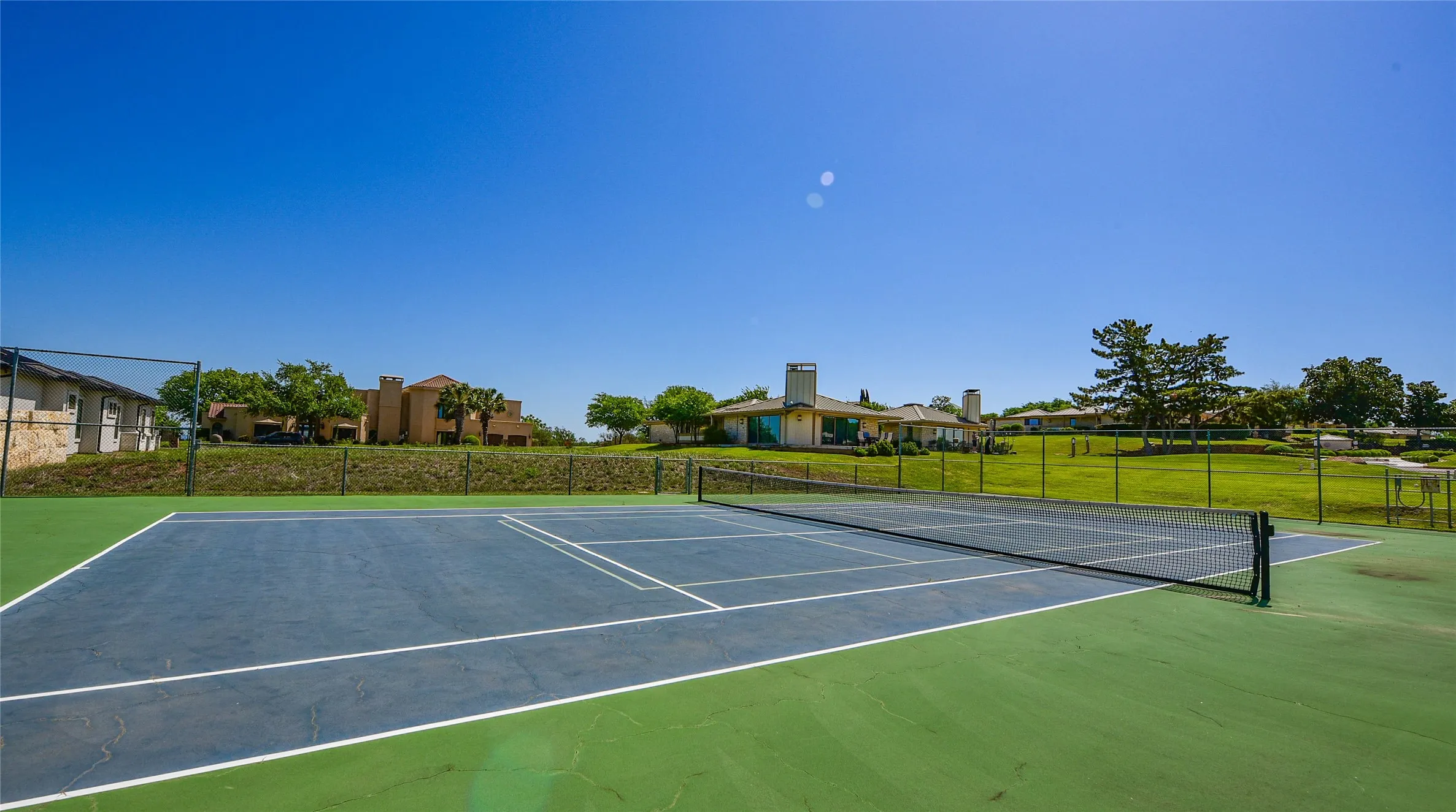 View of tennis court featuring community basketball court