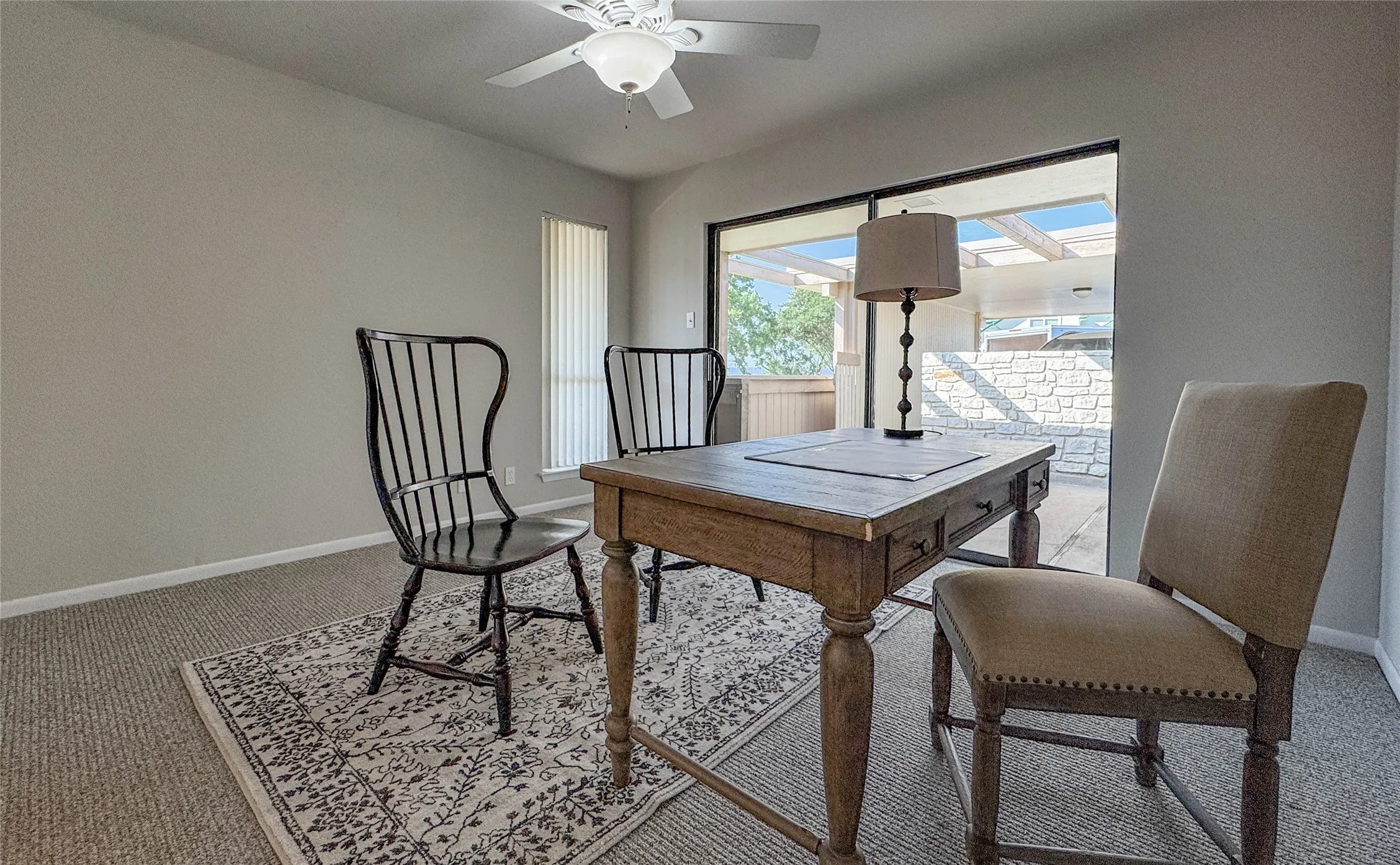 Office area with carpet flooring and a ceiling fan