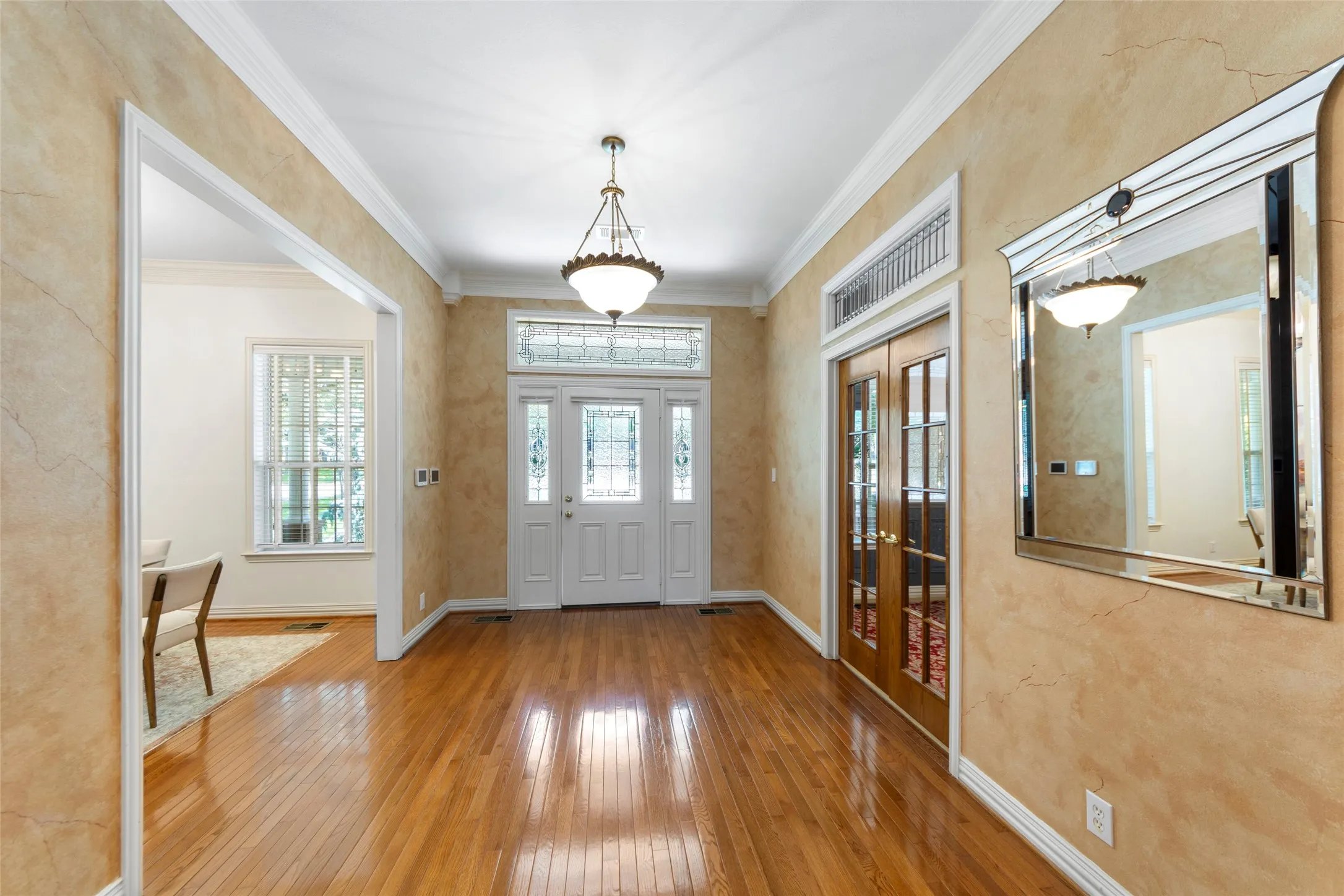 grand entry with leaded glass and hardwood floors