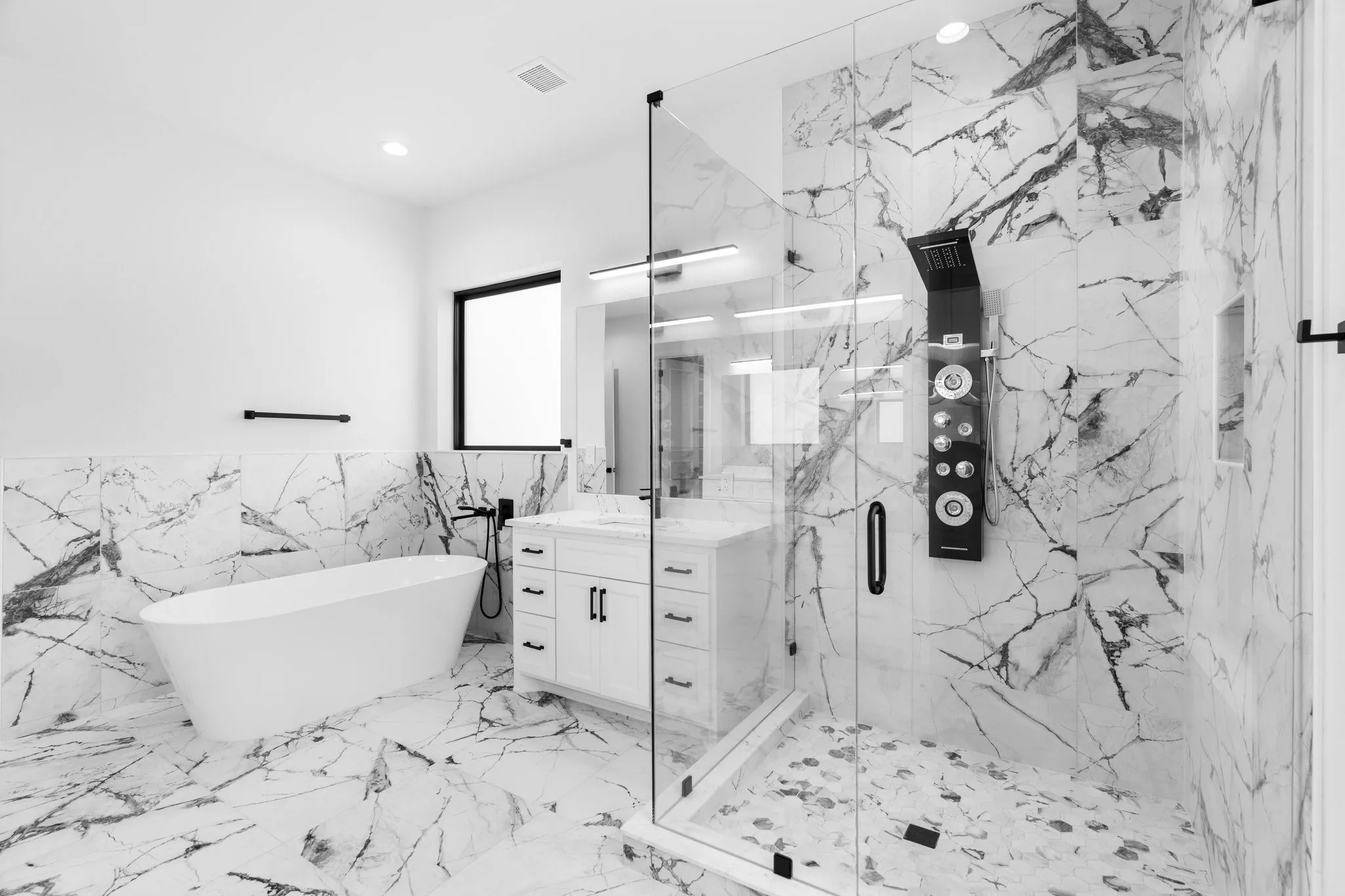 Full bathroom with tile walls, vanity, a marble finish shower, a soaking tub, and marble tiled floors