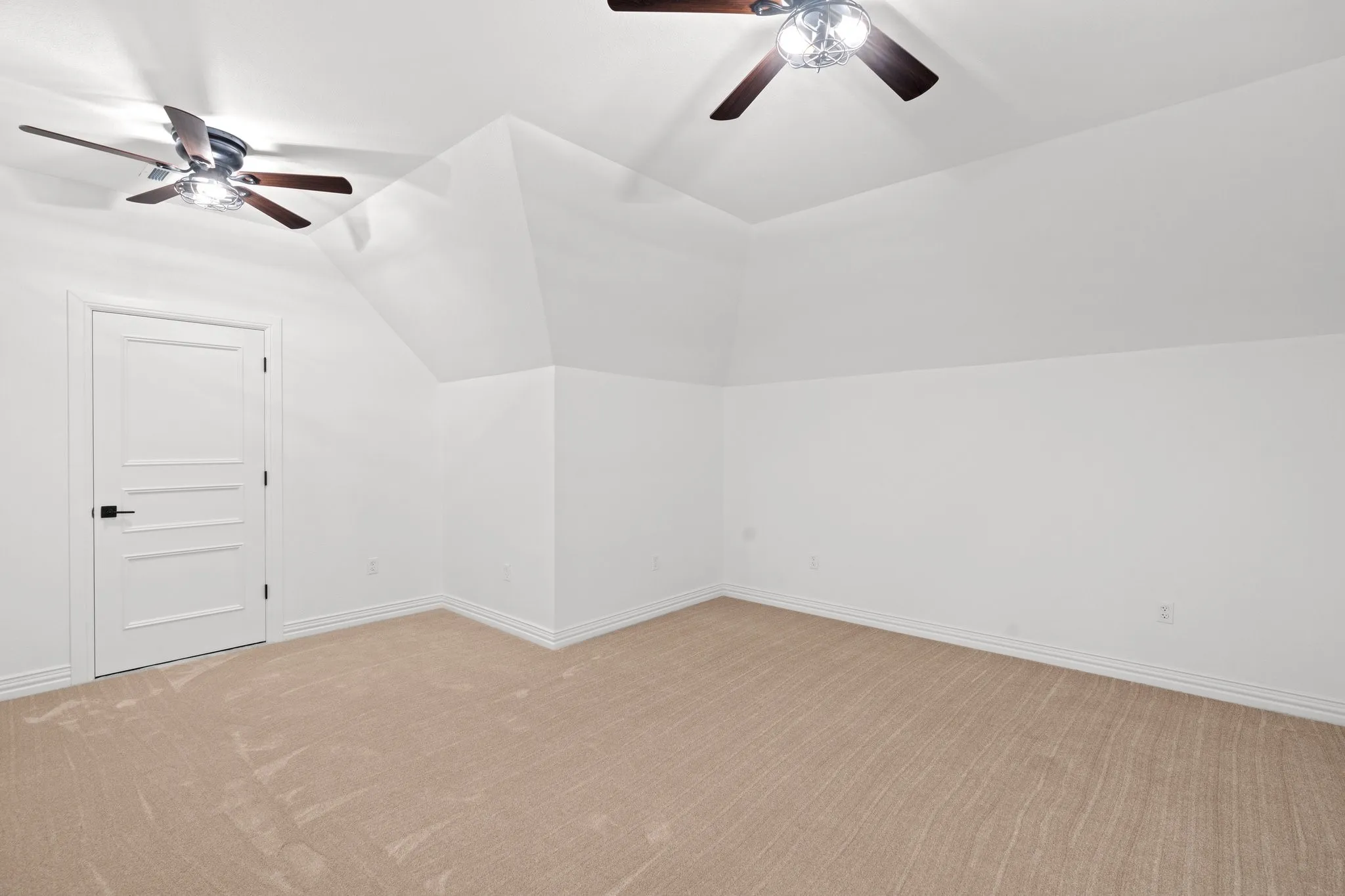 Bonus room featuring ceiling fan, light carpet, and vaulted ceiling