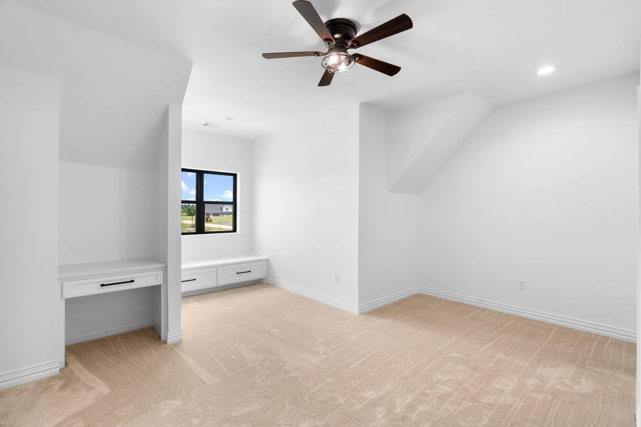 Additional living space with ceiling fan, light carpet, and recessed lighting