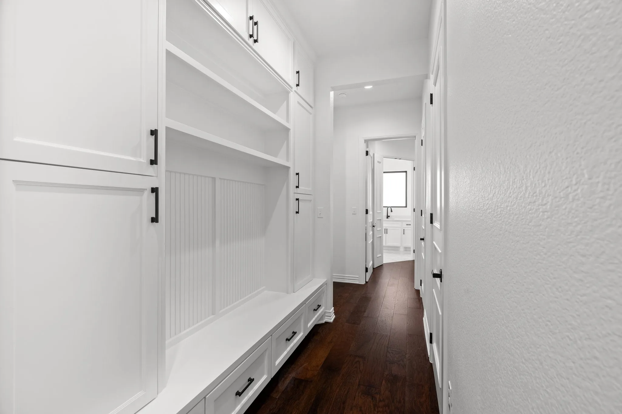 Mudroom featuring dark wood finished floors and recessed lighting