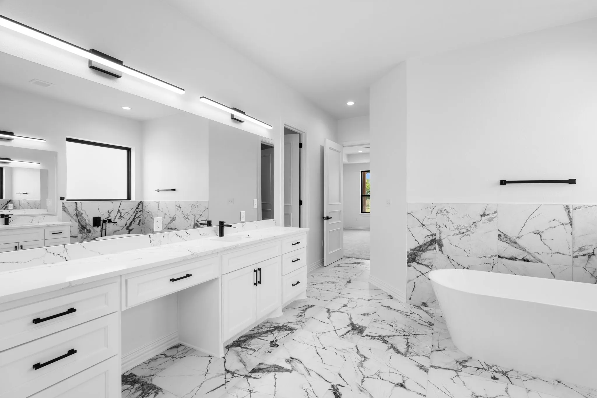 Bathroom with tile walls, vanity, a freestanding tub, recessed lighting, and plenty of natural light