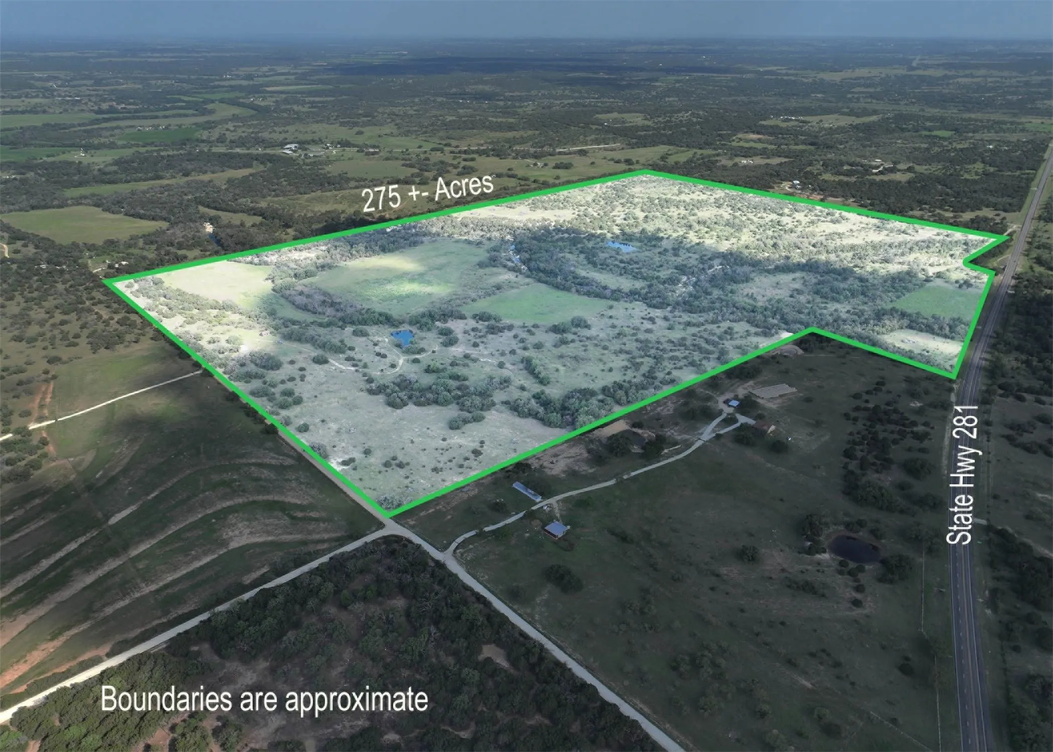 Aerial view of sparsely populated area featuring property parcel outlined