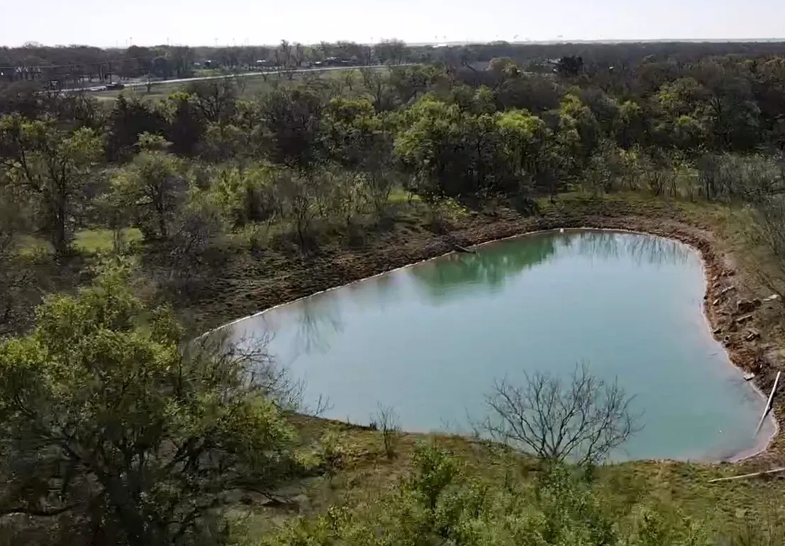Aerial view of property's location with a large body of water