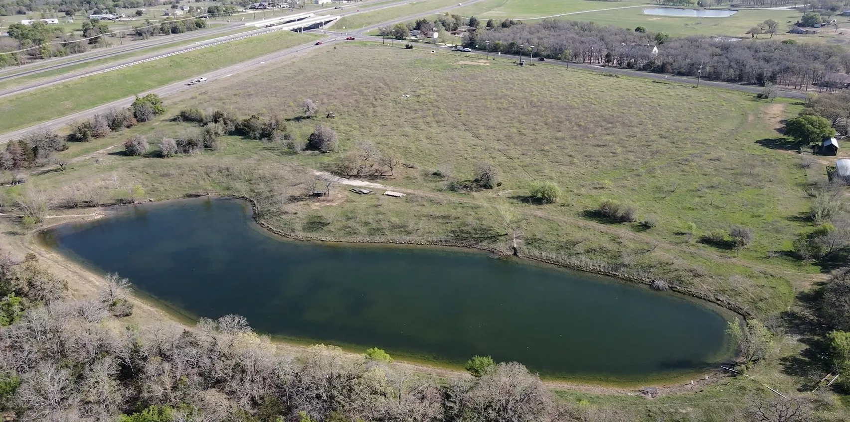 Aerial overview of property's location featuring a large body of water and rural landscape