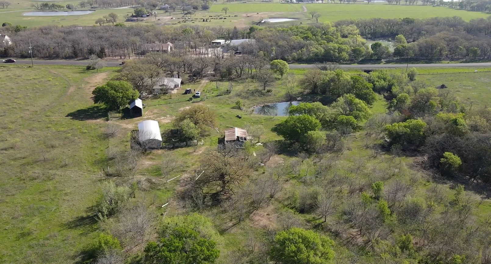 Aerial overview of property's location with a nearby body of water and rural landscape