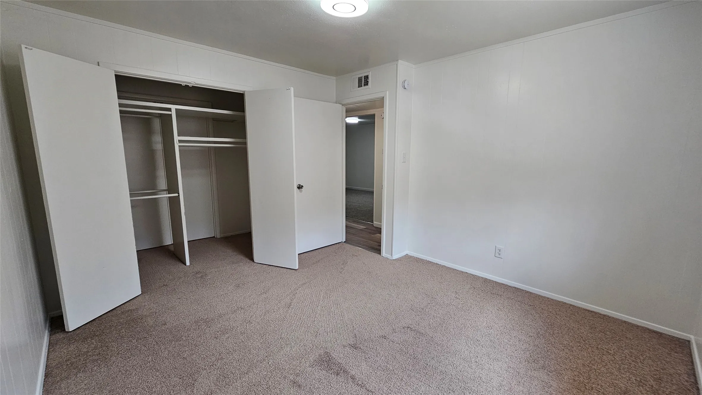 Unfurnished bedroom featuring carpet floors and a closet