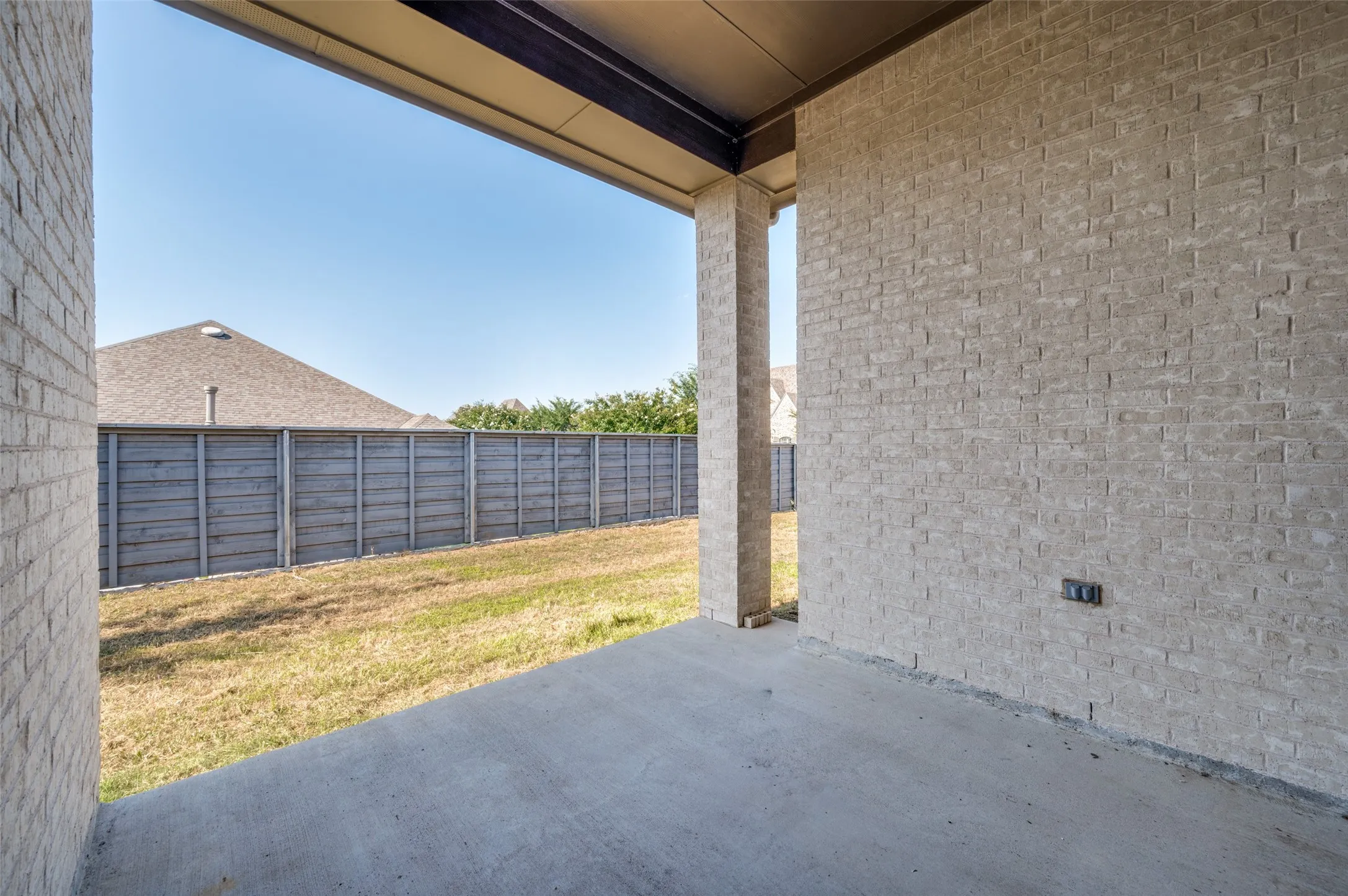 Fenced backyard with a patio area