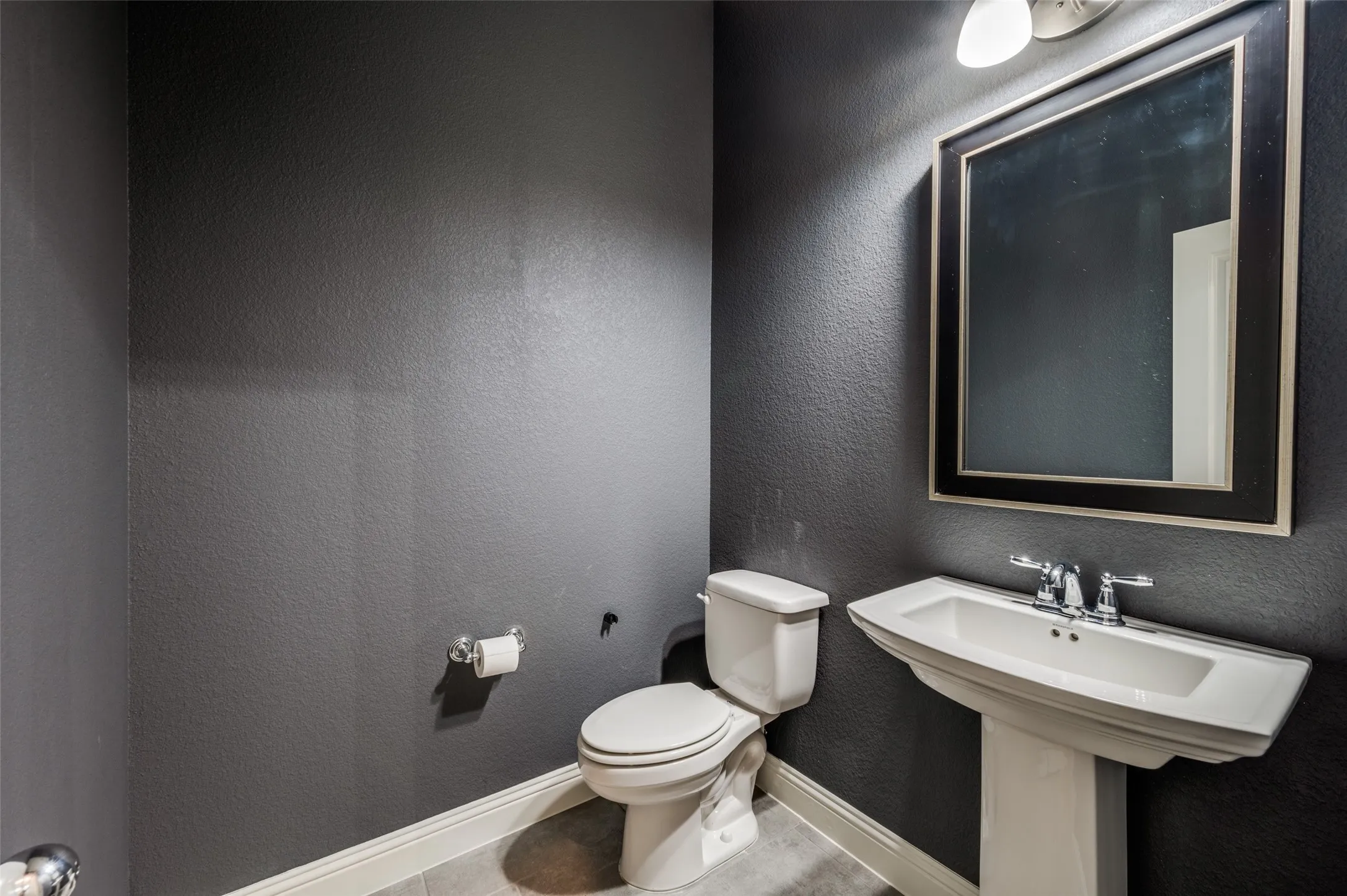 Bathroom featuring toilet and tile patterned floors
