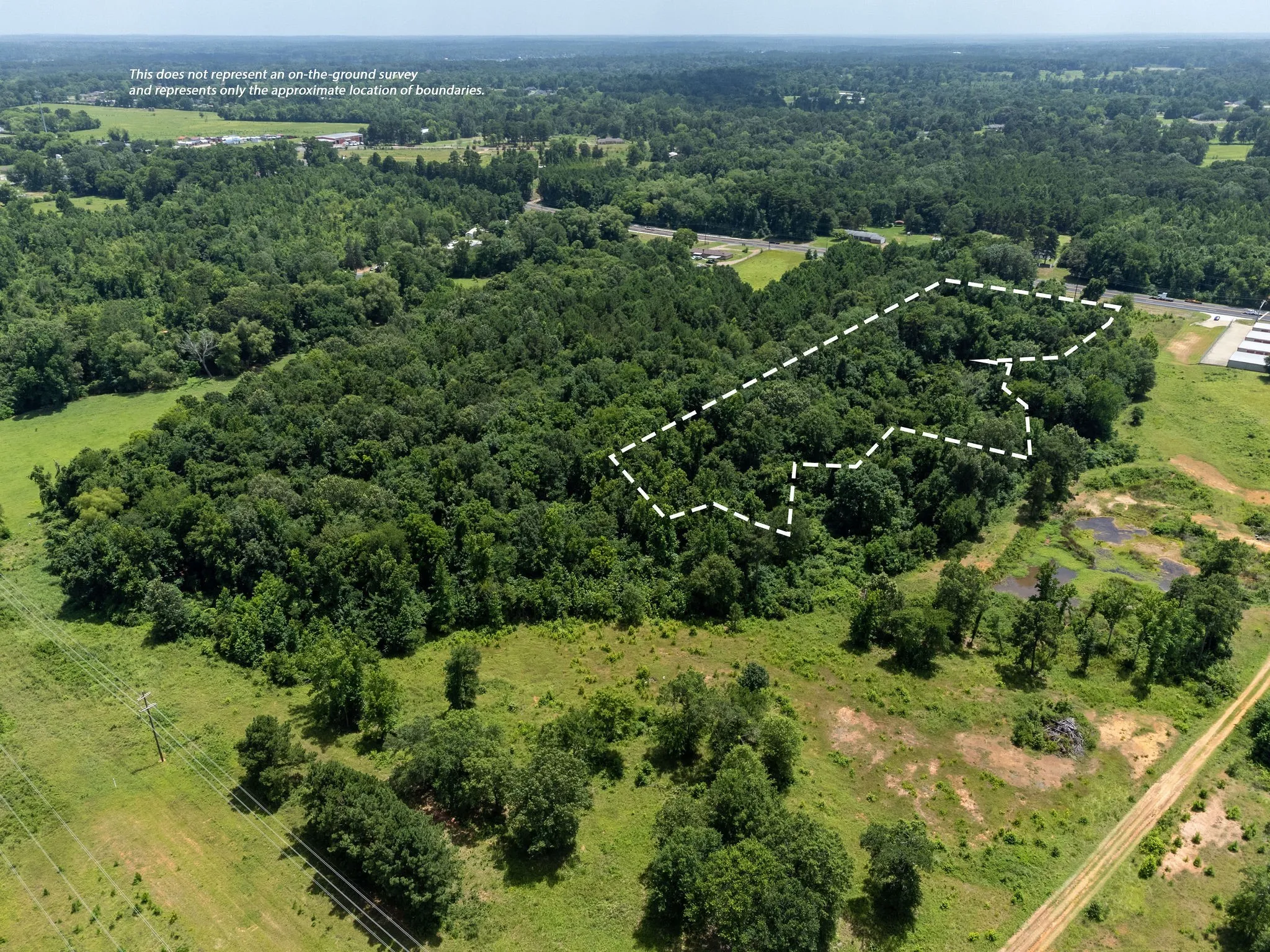 View of property location with property parcel outlined and a heavily wooded area