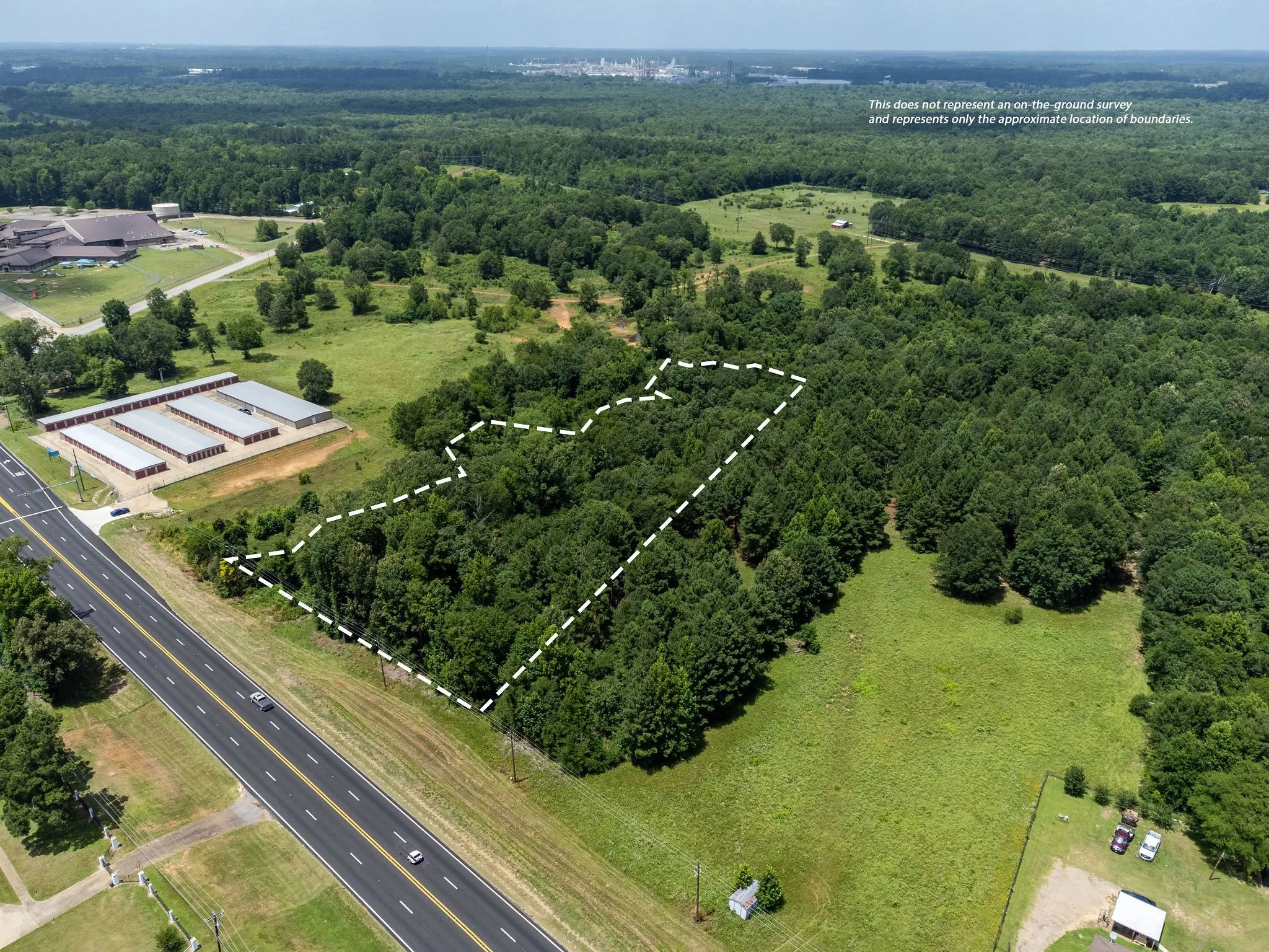 View of property location featuring a forest