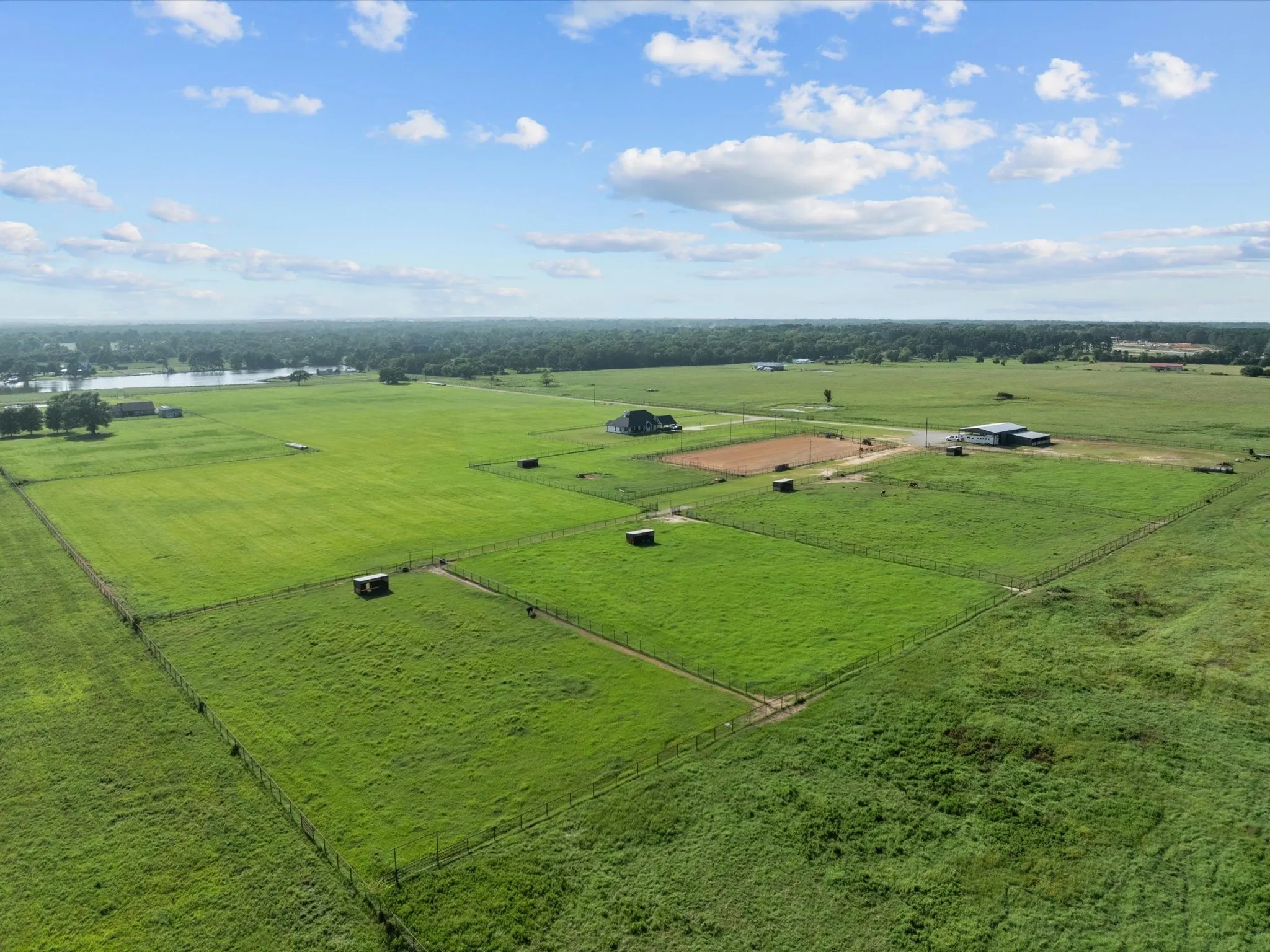 Overview of rural landscape featuring a nearby body of water and a pastoral area