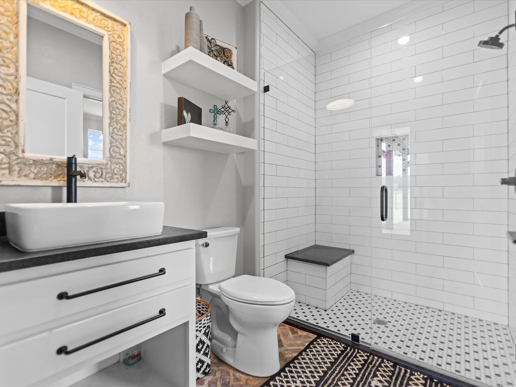 Full bath with a shower stall and vanity