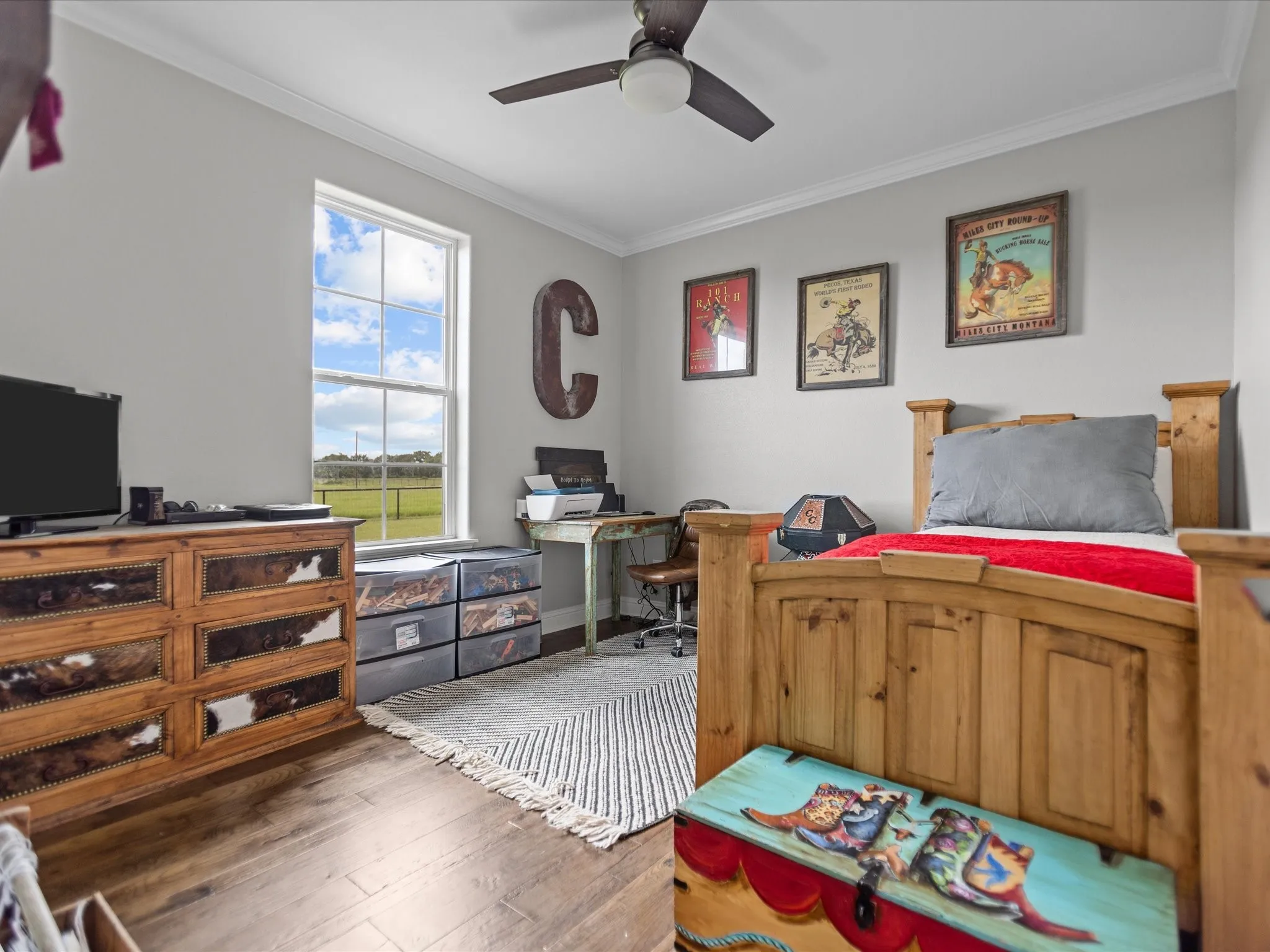 Bedroom with crown molding, wood-type flooring, a desk, and a ceiling fan
