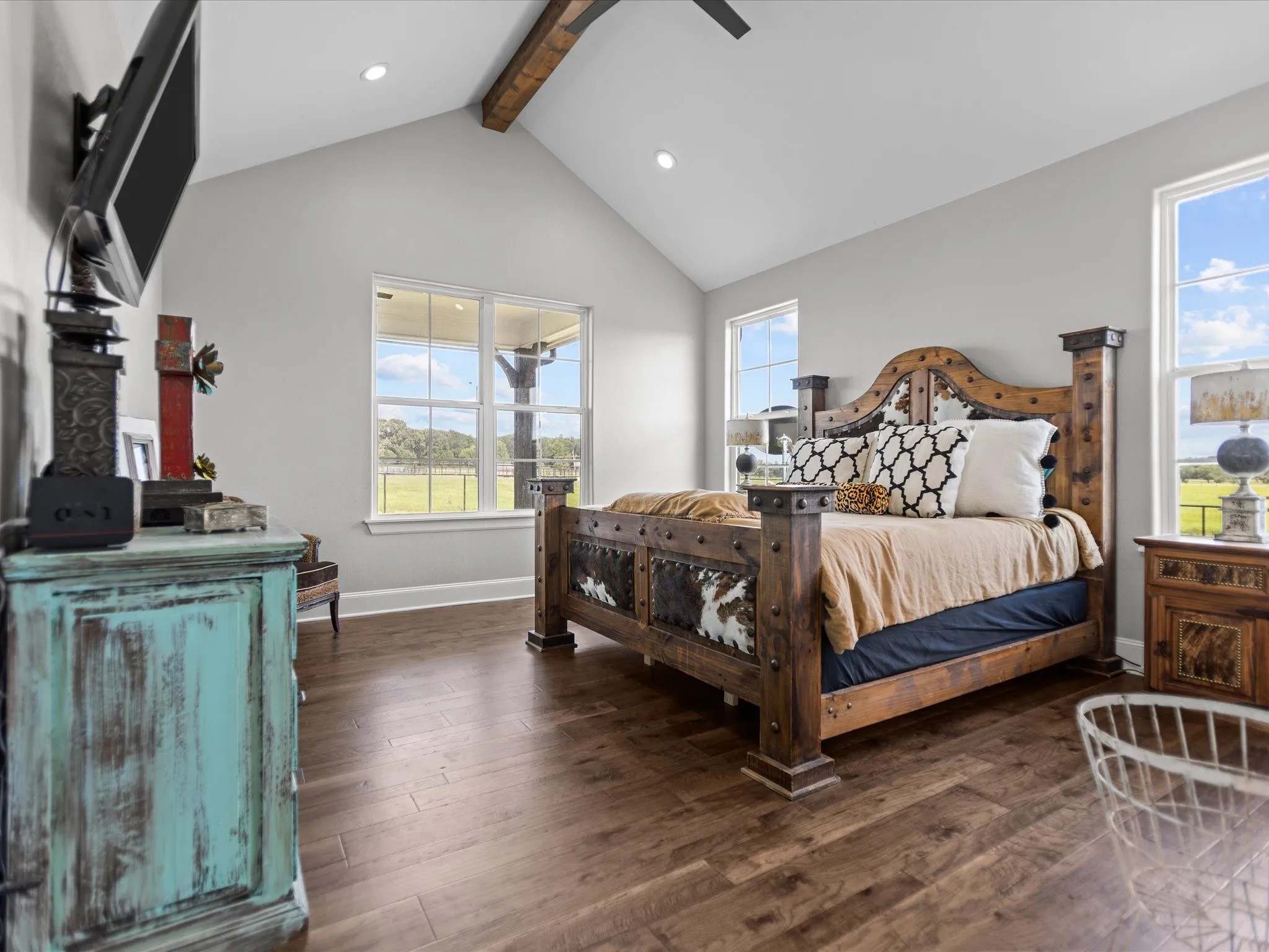 Bedroom with beam ceiling, wood finished floors, recessed lighting, high vaulted ceiling, and a ceiling fan